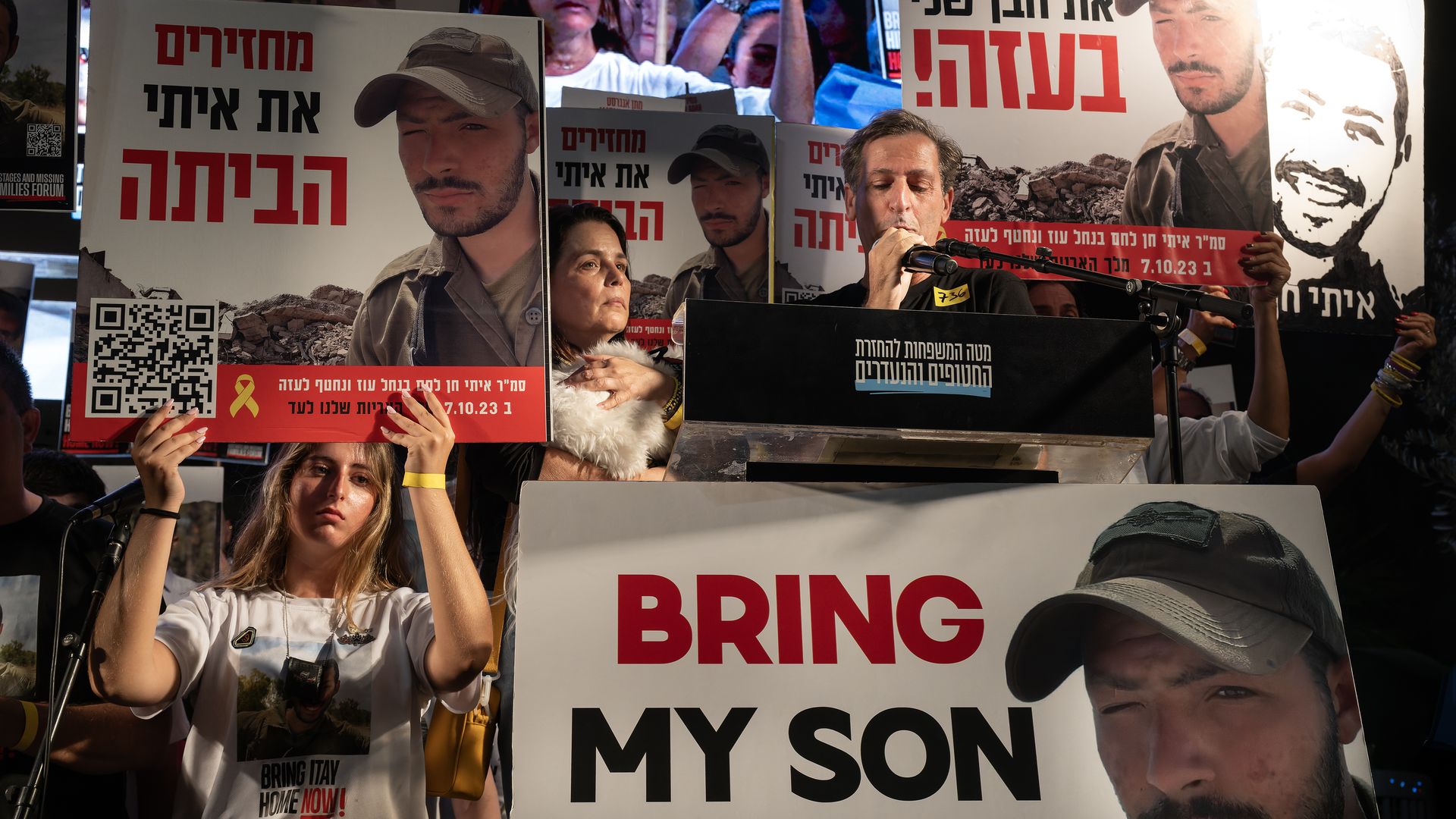 The parents of the fallen hostage Itay Chen hold photos of him during a demonstration in Tel Aviv, Israel, last month. 