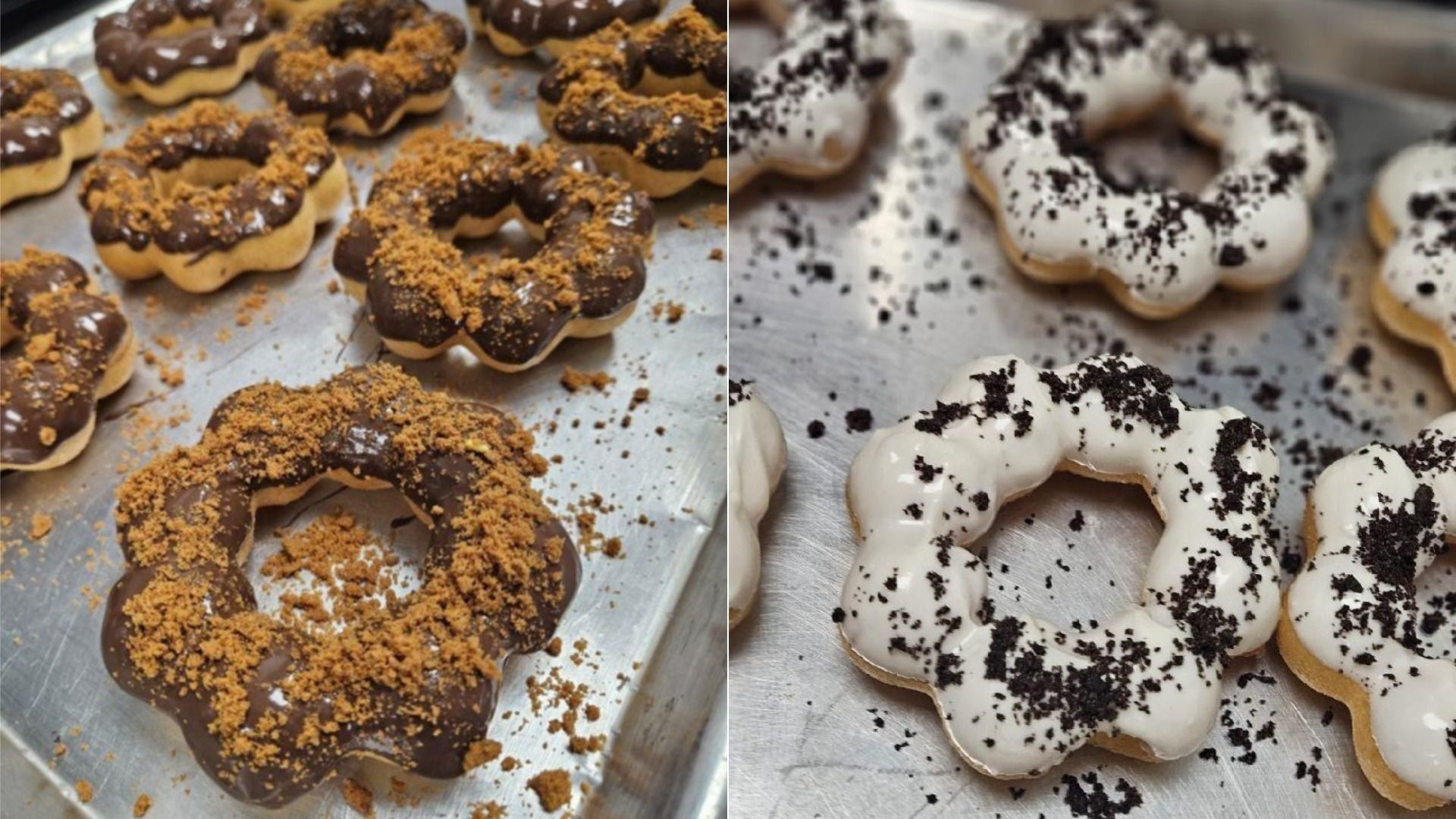 Two sets of flower-shaped donuts on a metal tray; one set is coated in chocolate with brown crumb topping, the other in white icing with black crumb topping.