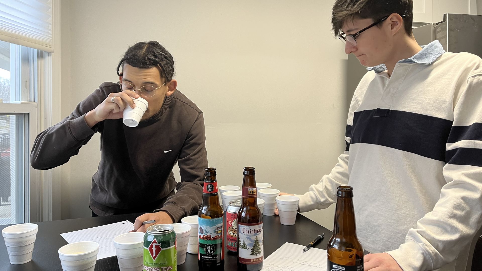 Sam and Annalise rate Christmas beers. Photo: Joe Guillen/Axios
