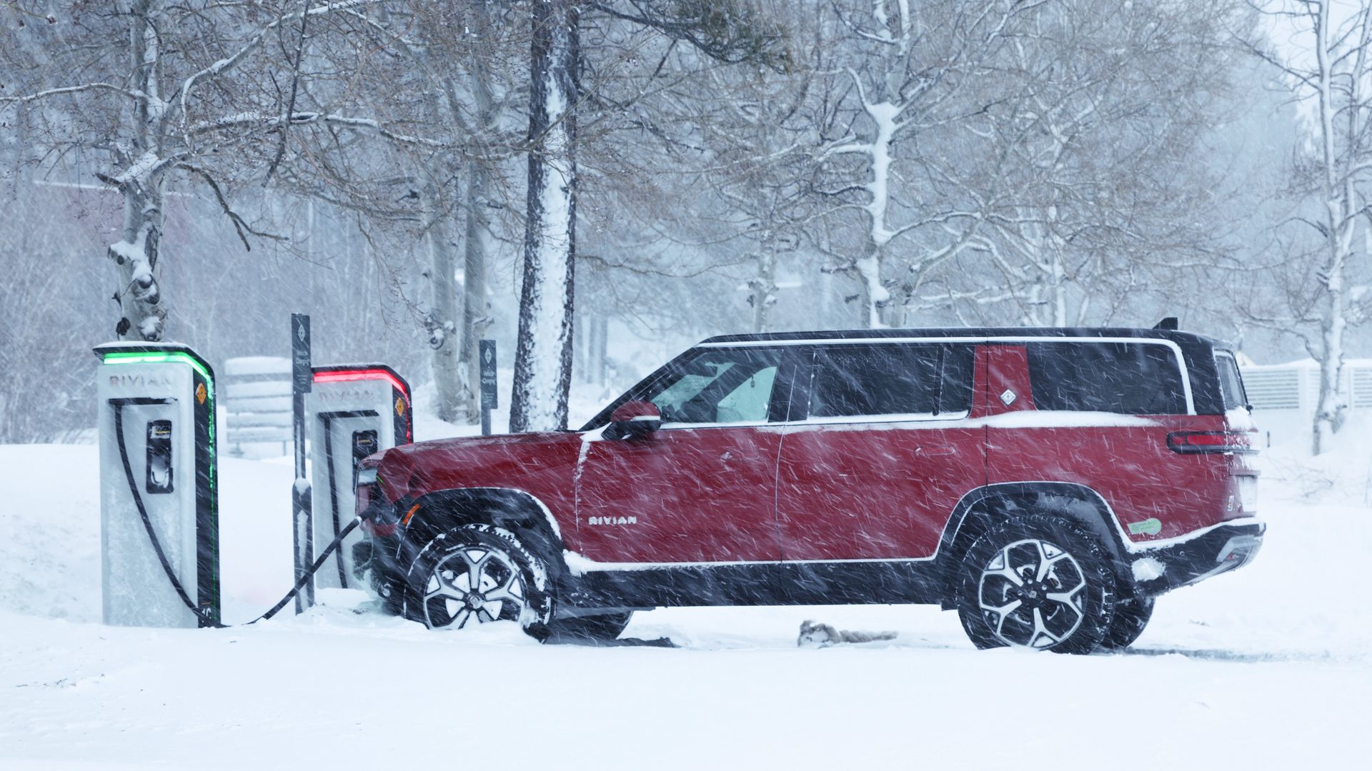 Photo of a Rivian SUV at a charging station during a snowstorm in Truckee, Calif.