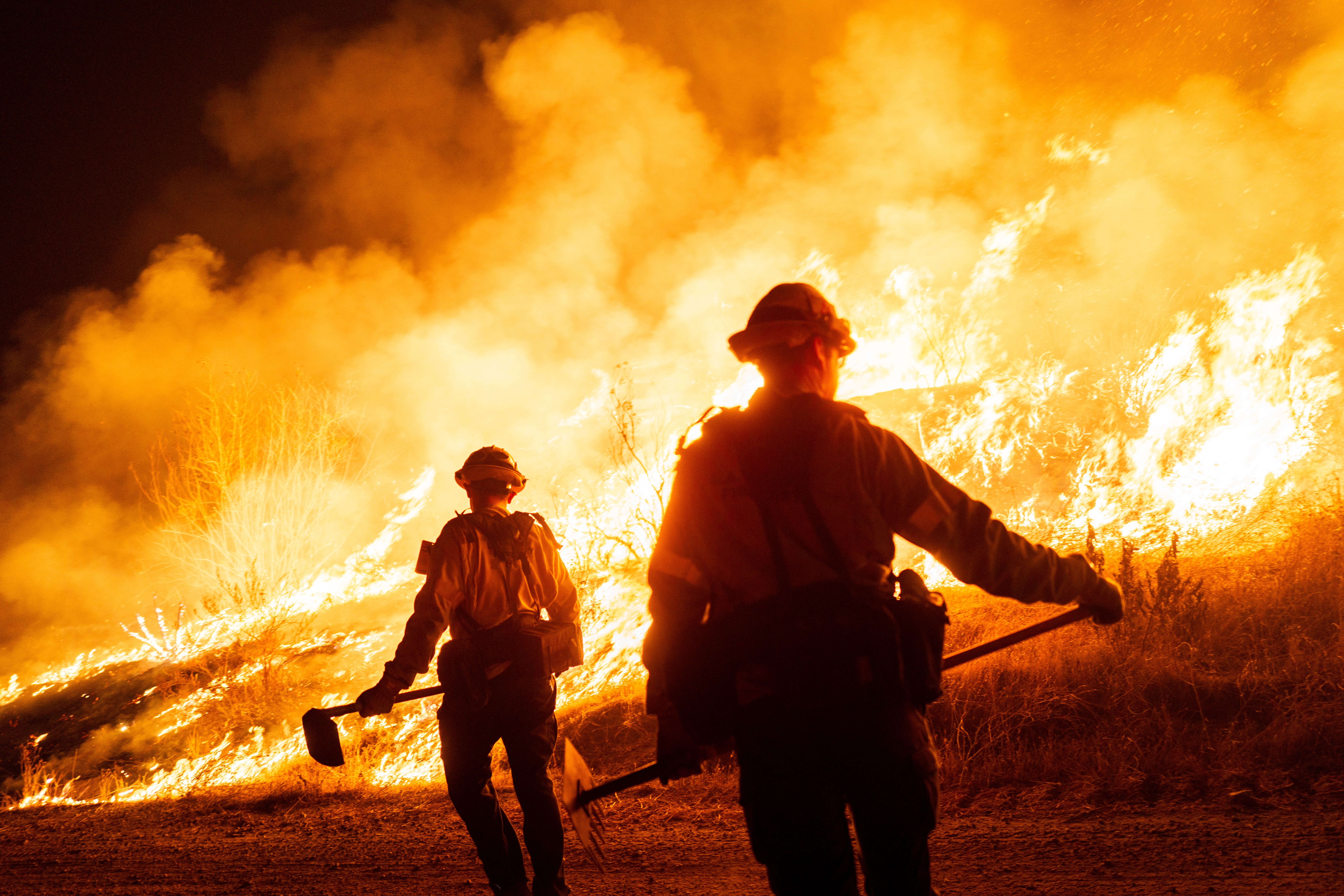 Firefighters work as the Hughes Fire burns on January 22, 2025 in Castaic, California