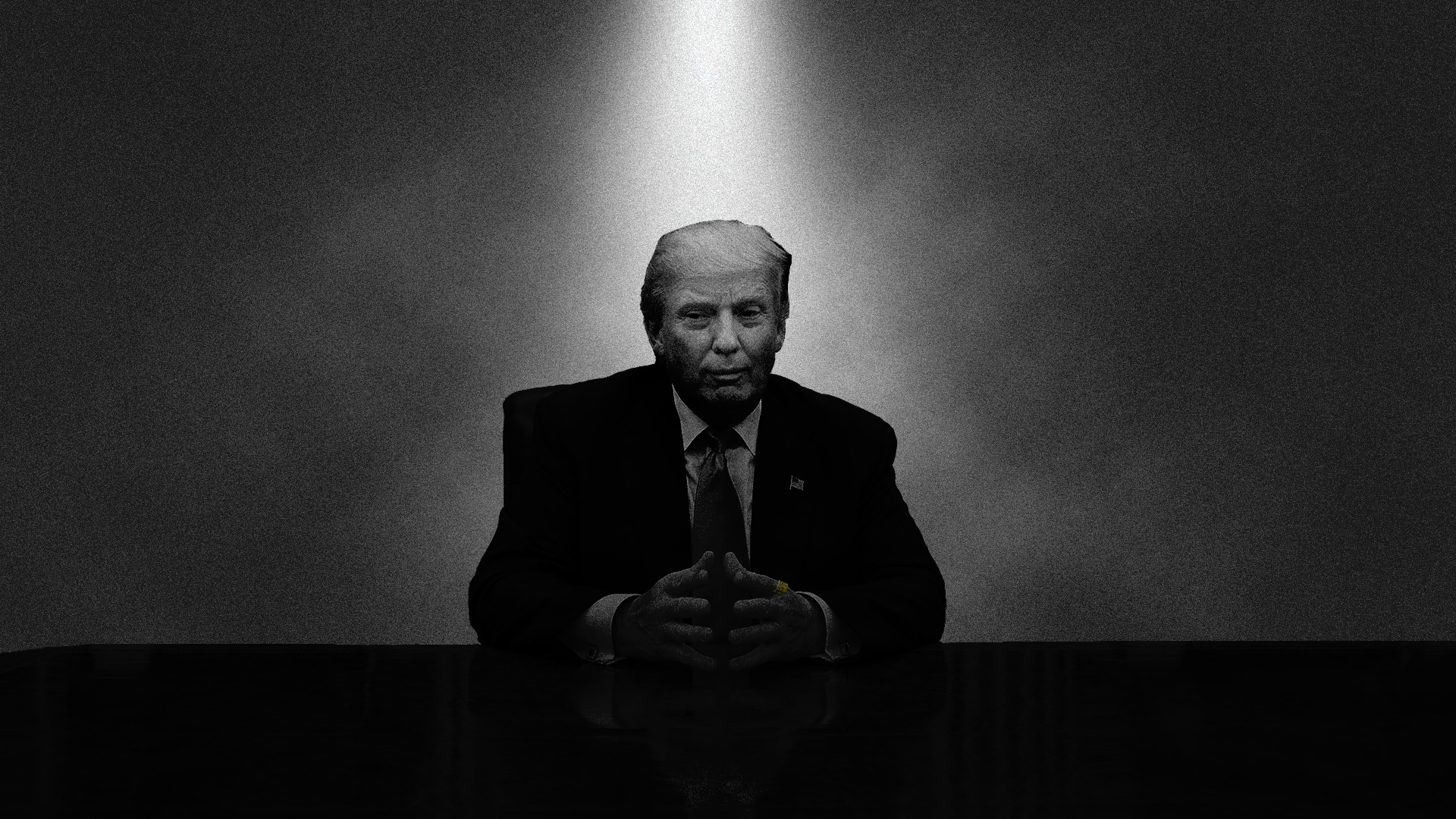 Black and white noir photo illustration of President Trump behind a desk with an overhead light.