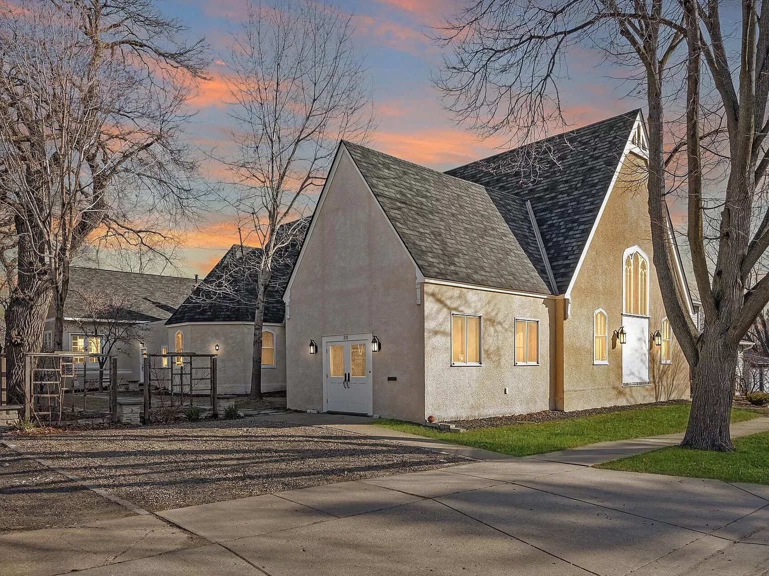 A photo of a church with yellow stucco walls.