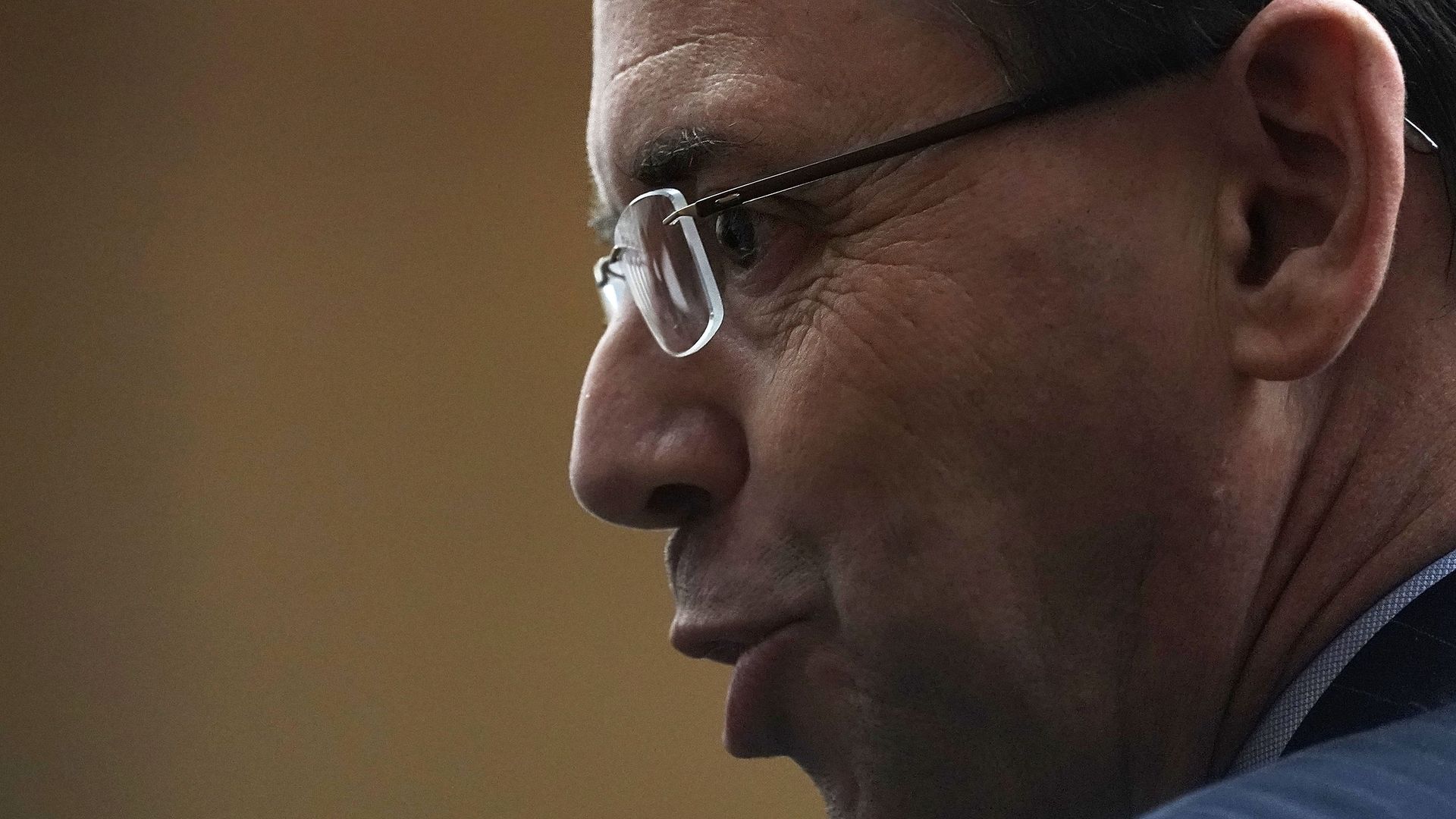 Profile of Rod Rosenstein wearing glasses with his lips puckered 