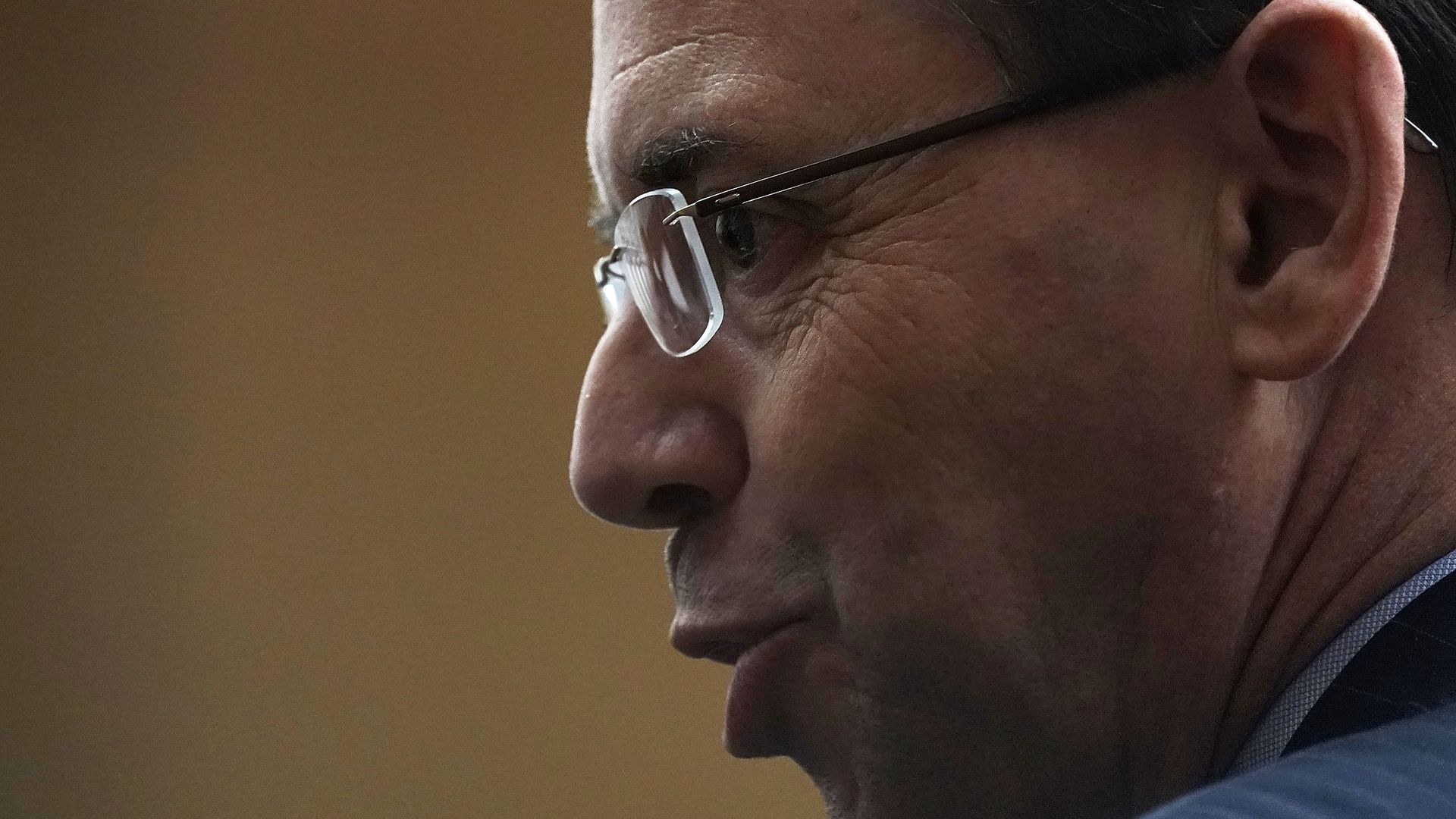 Profile of Rod Rosenstein wearing glasses with his lips puckered
