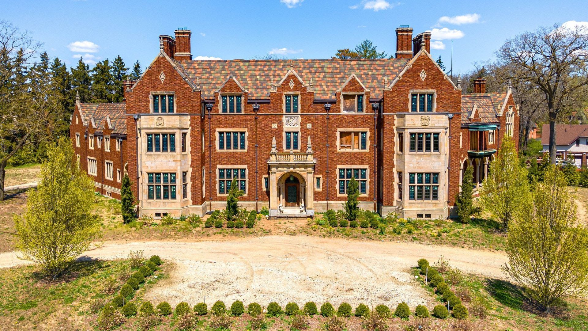 The giant house with red bricks and multi-story design features.
