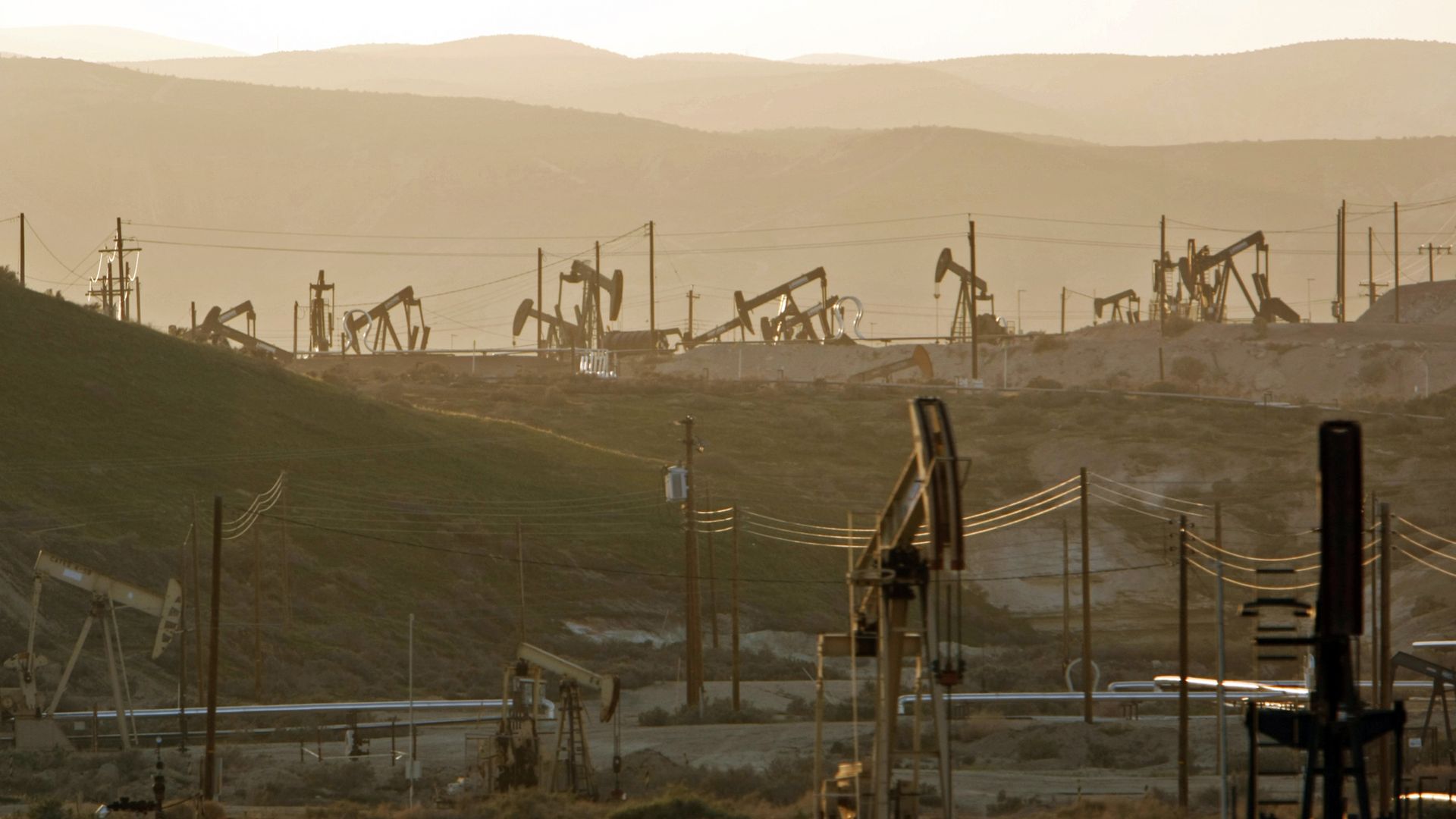 Oil rig pump jacks work the oil fields near the town of Maricopa