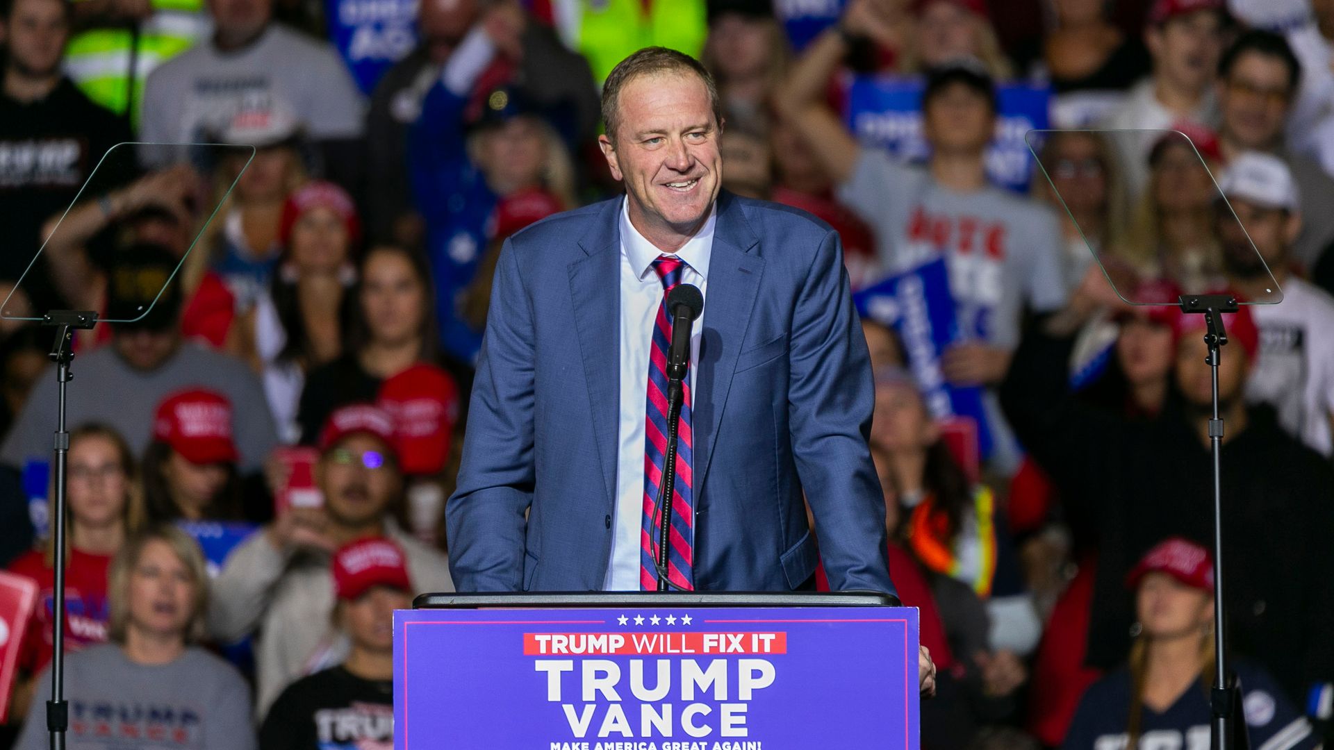 Sen. Eric Schmitt speaks to a crowd at a Trump rally.