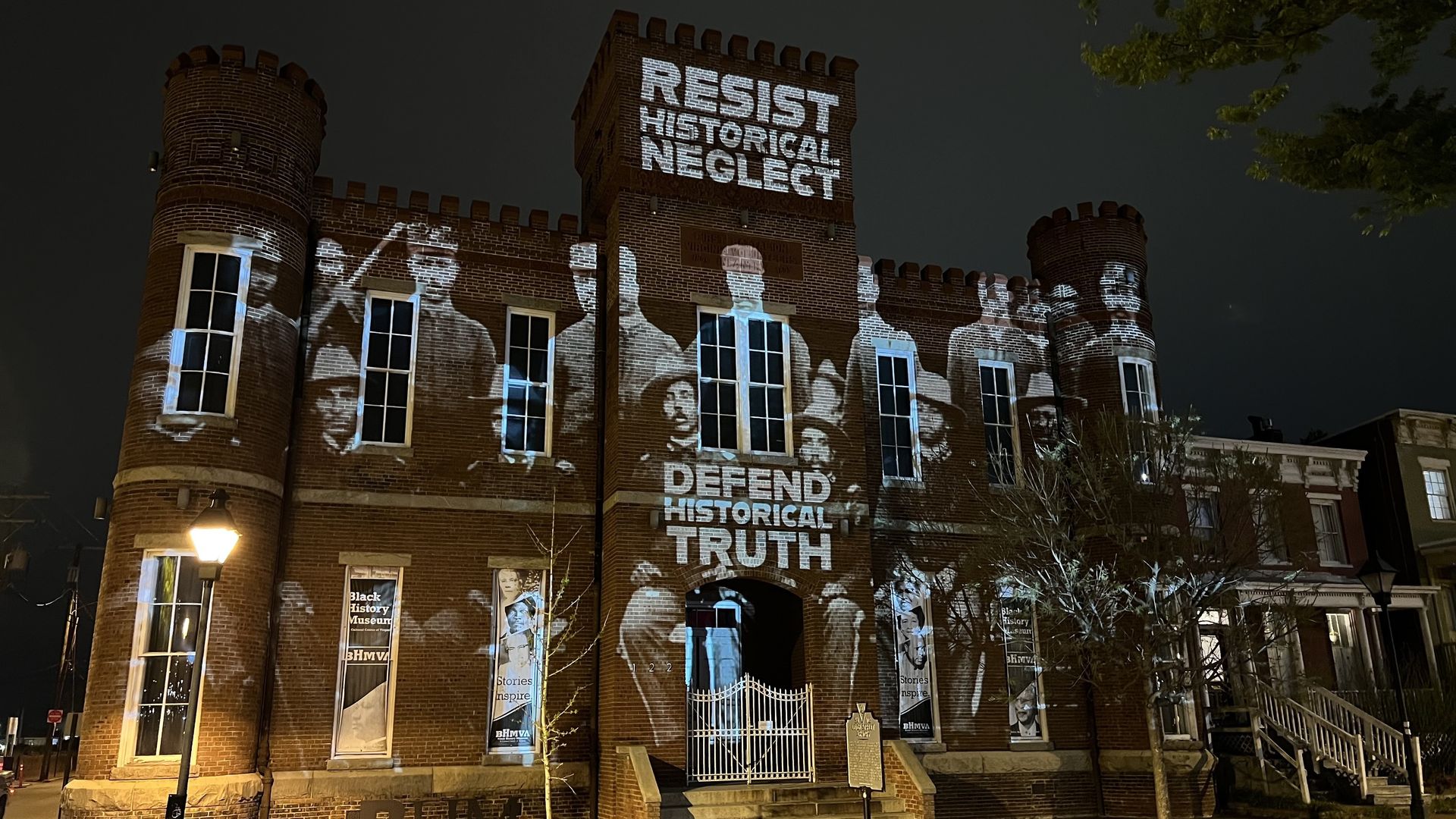 A building covered in images that say Resist historical neglect and defend historical truth 