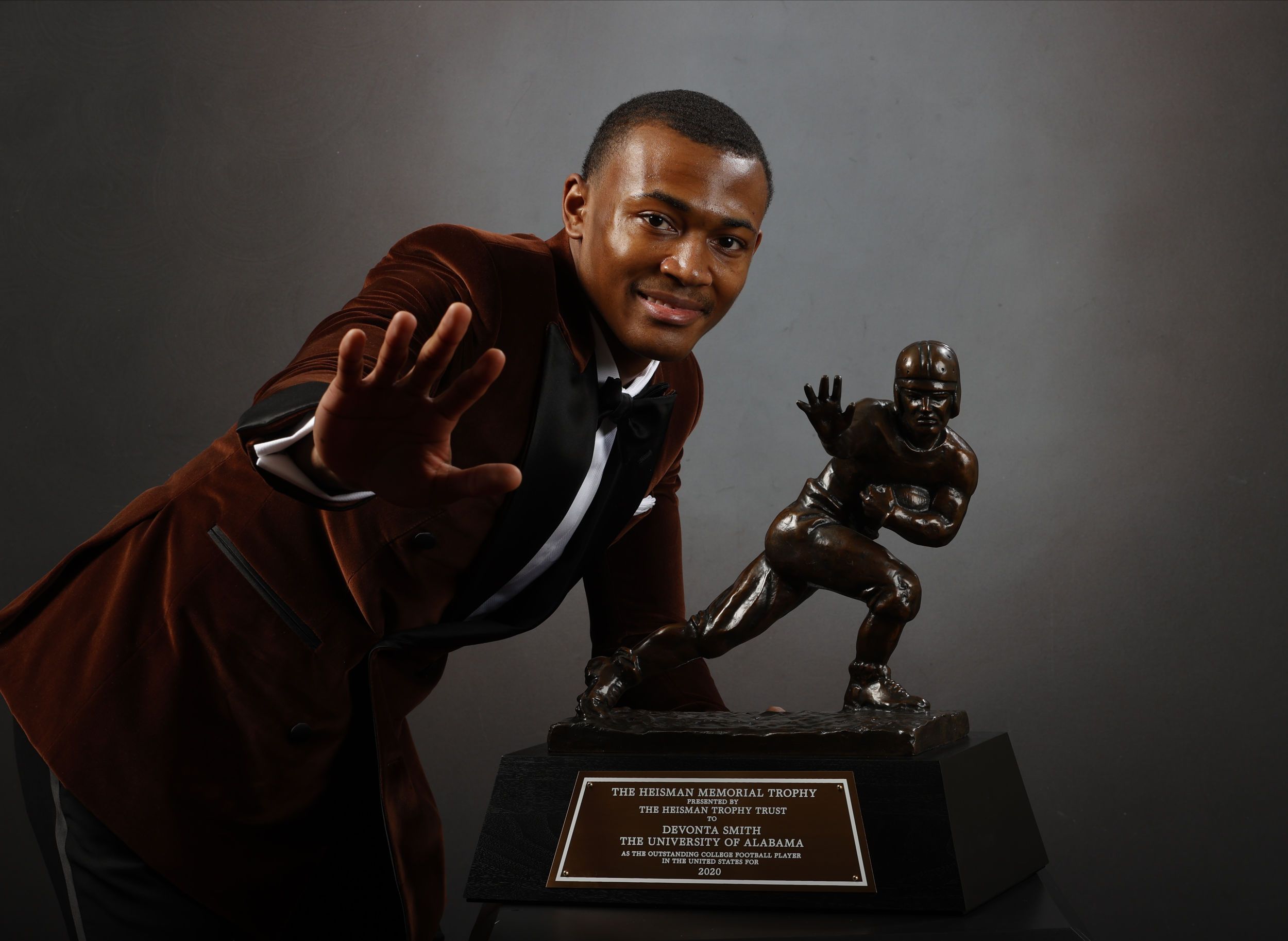 DeVonta Smith poses with the Heisman Trophy