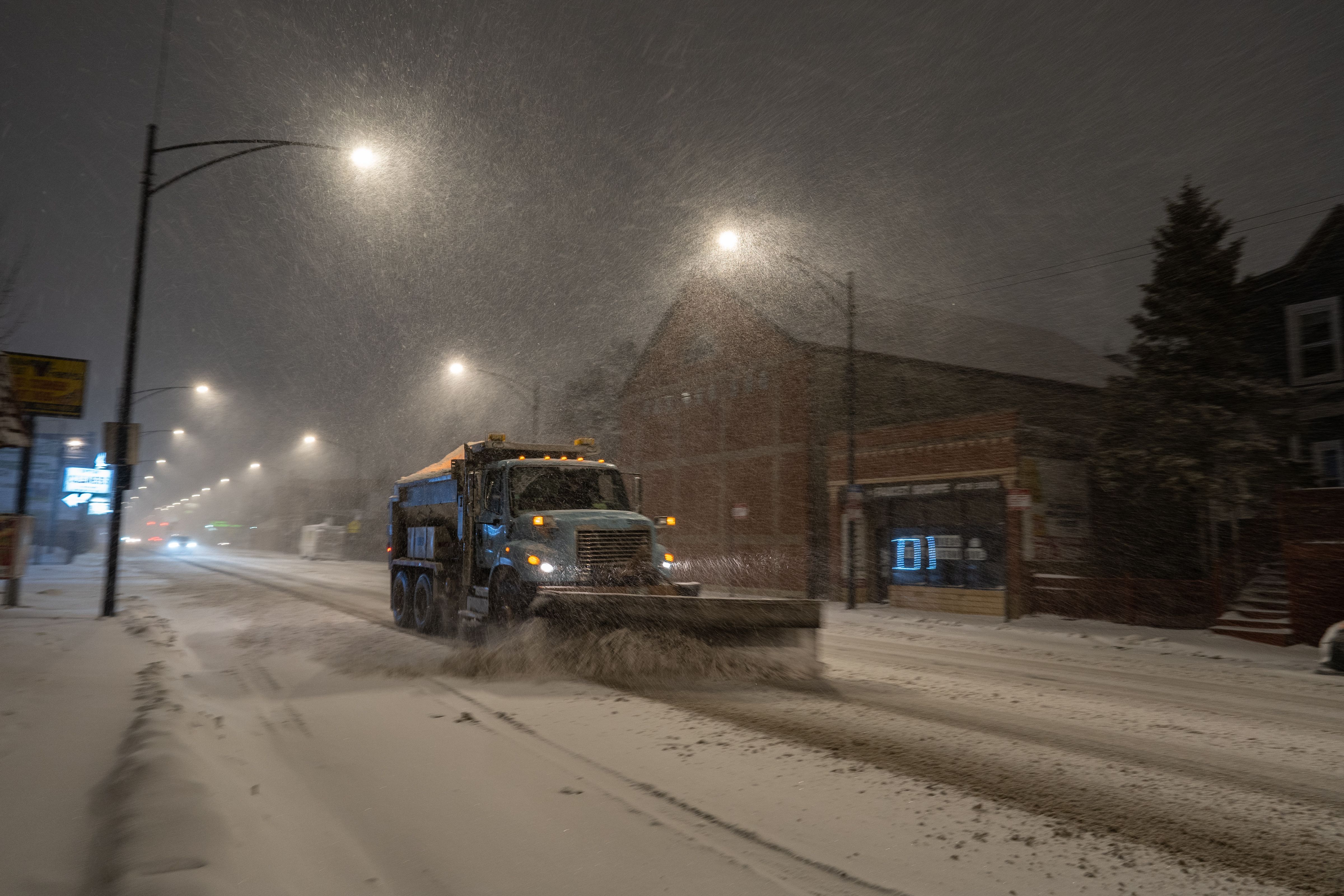 A snow plow clears streets during a Winter Storm Warning in Chicago, IL on January 30