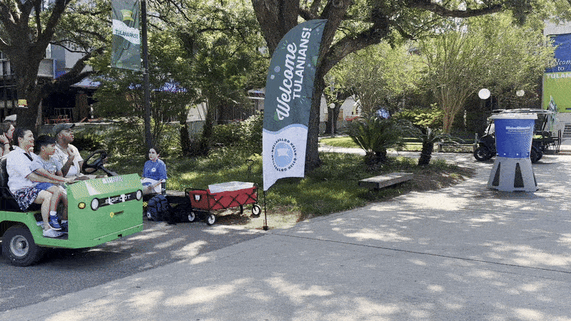 Video shows a green cart driving a student and their family on Tulane's campus.