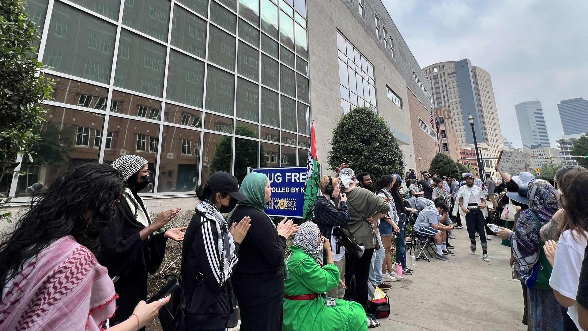 Photo of people protesting outside of the Harris County Joint Processing Center