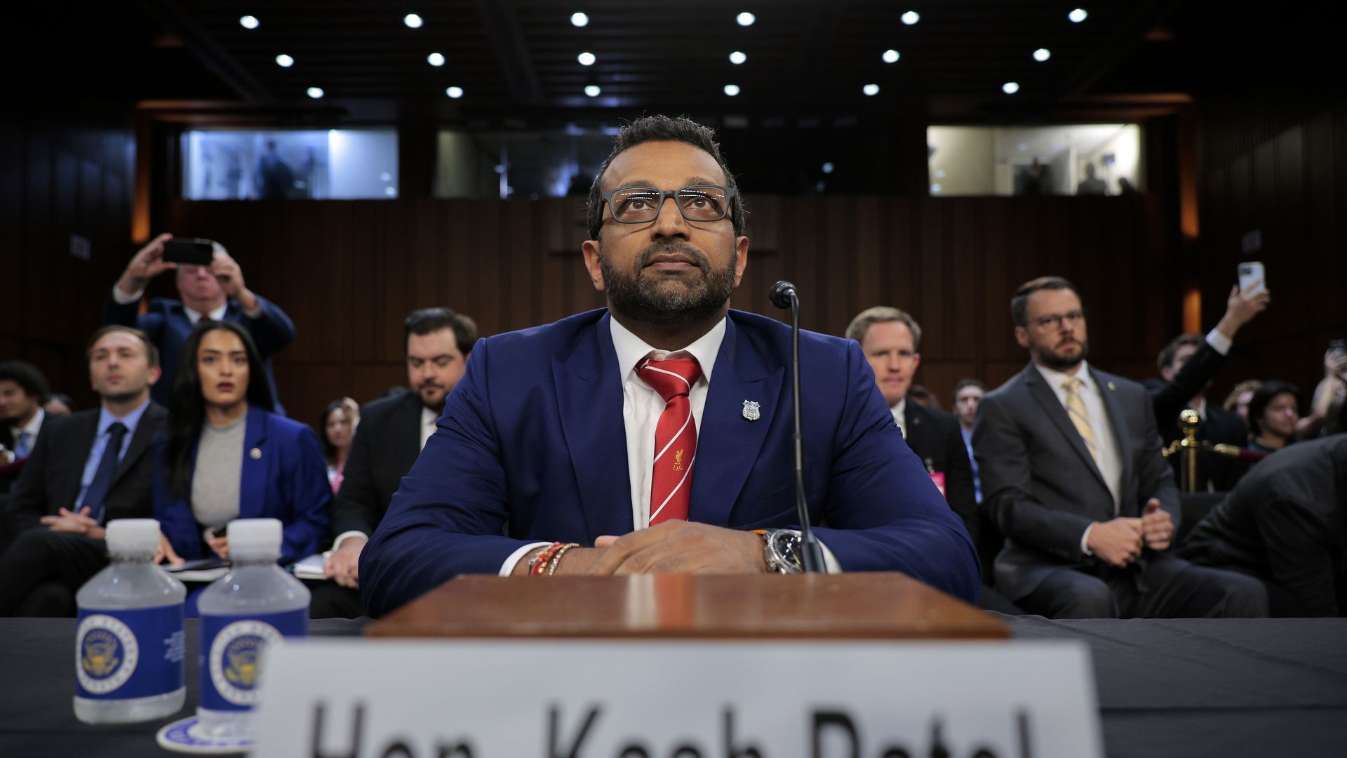 Kash Patel seated with several people behind him 