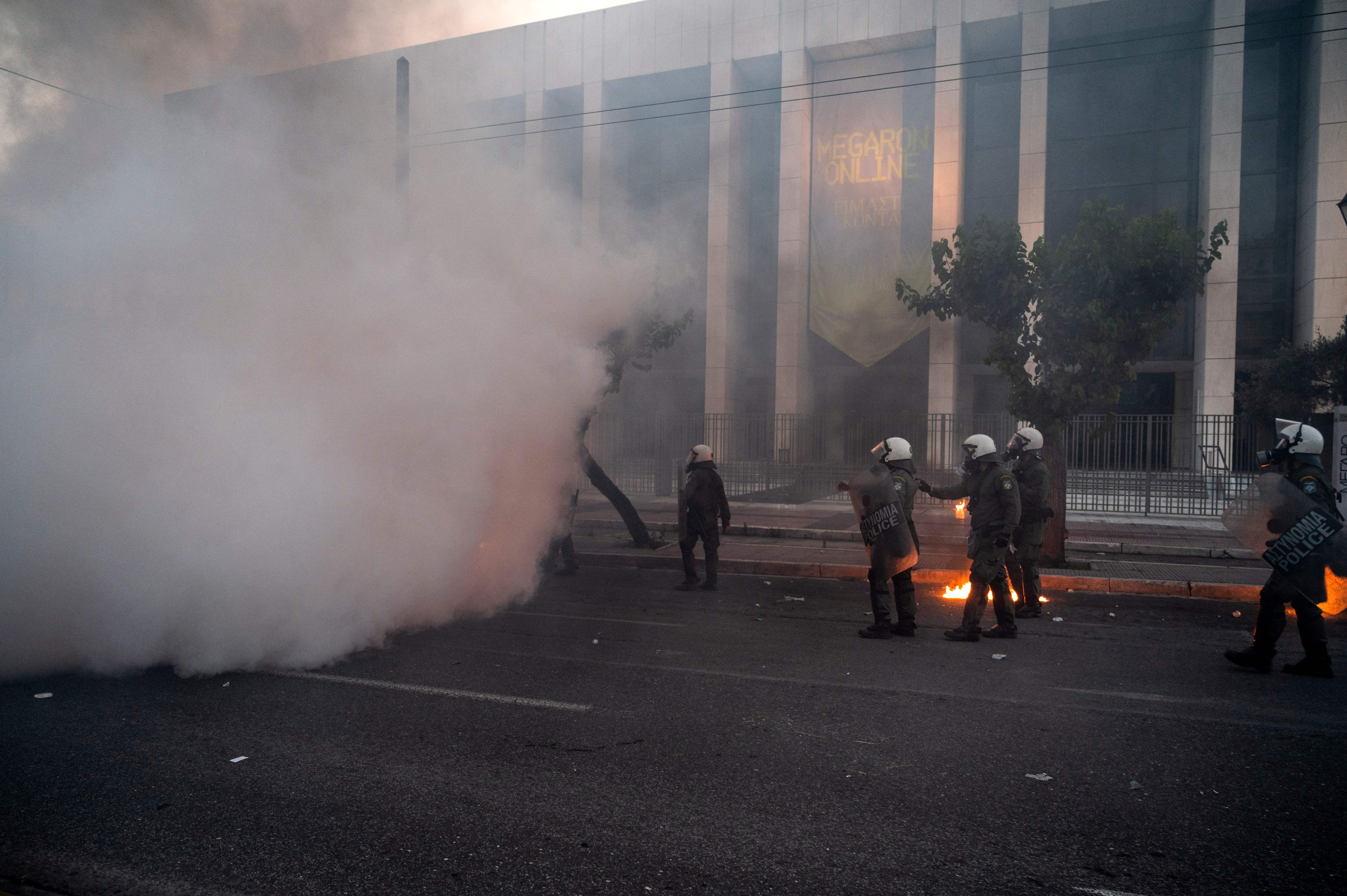 Riots police stand among tear gas during clashes with protesters outside the U.S. embassy in Athens on June 4. 