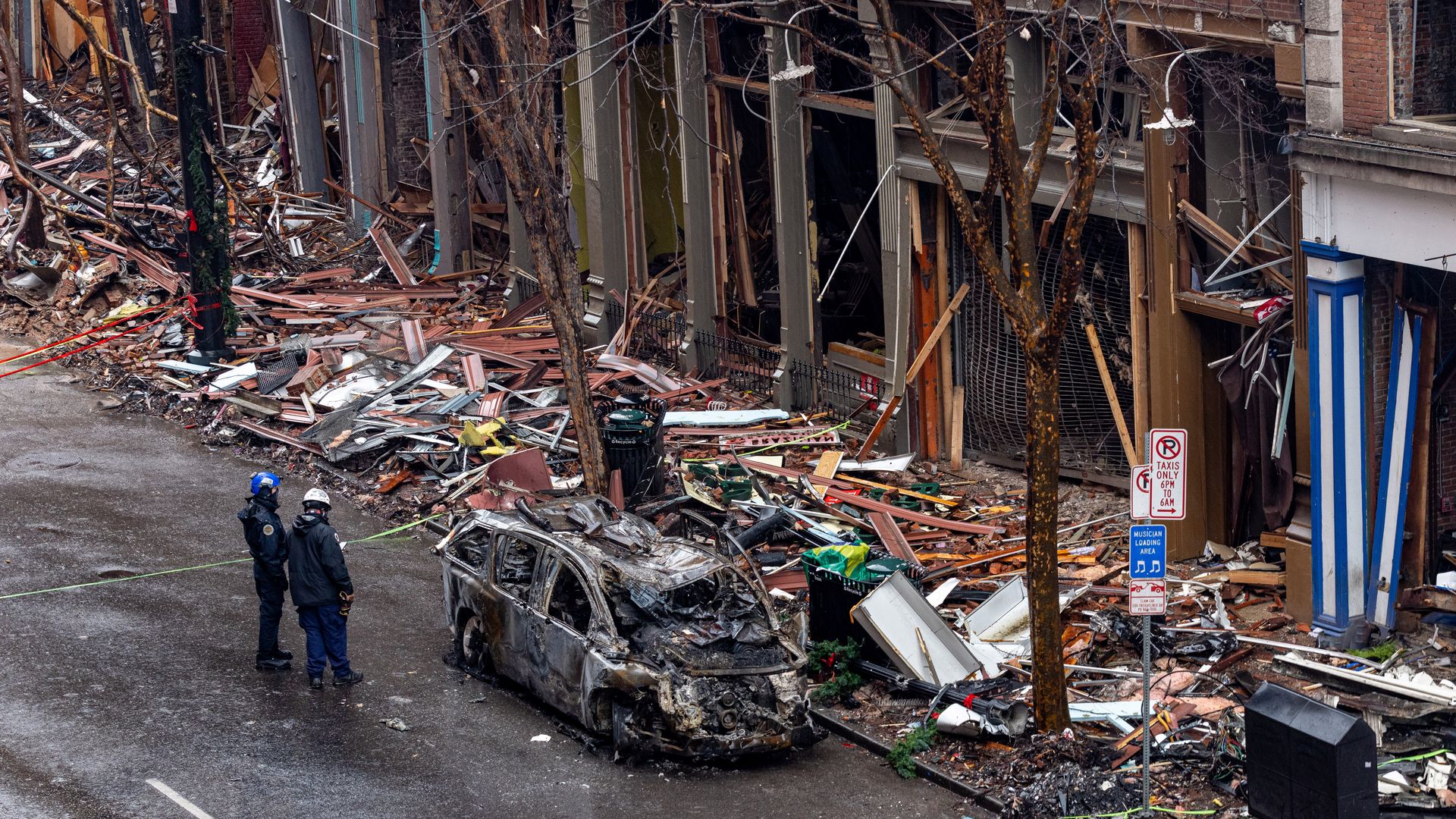 Police officers survey damage of buildings on historic Second Avenue in Nashville.
