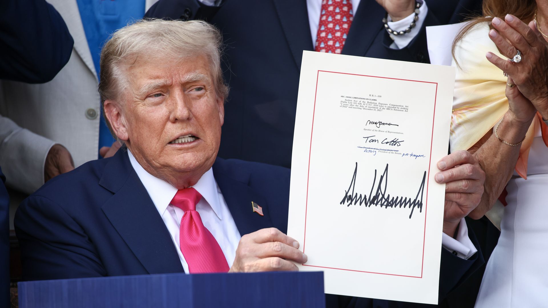 U.S. President Donald Trump, joined by Republican lawmakers, signs the One, Big Beautiful Bill Act into law during an Independence Day military family picnic on the South Lawn of the White House.