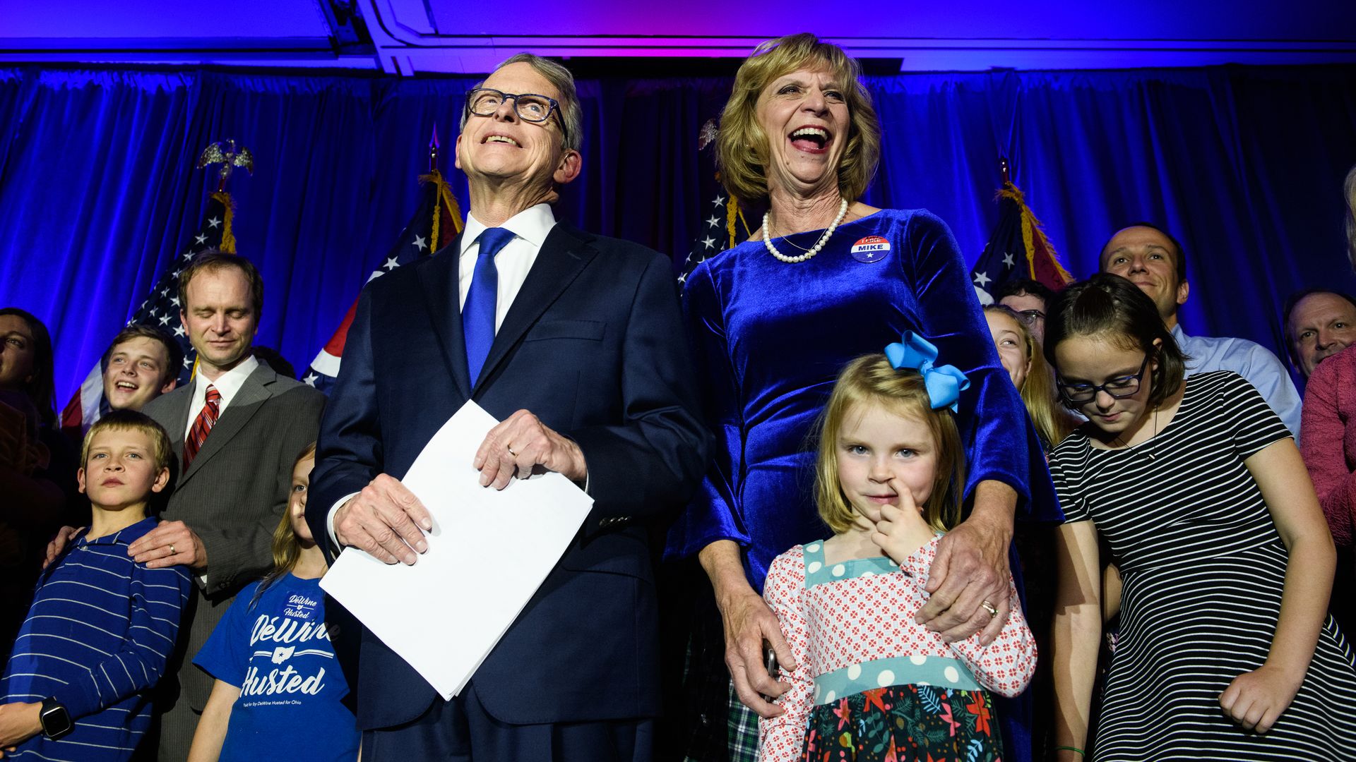 Ohio Governor Mike DeWine and First Lady Fran DeWine standing with their grandchildren.
