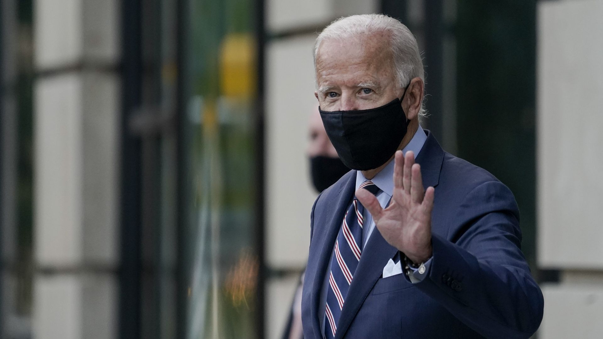 Democratic presidential nominee and former Vice President Joe Biden waves as he leaves the Hotel Dupont after having internal campaign meetings on September 16