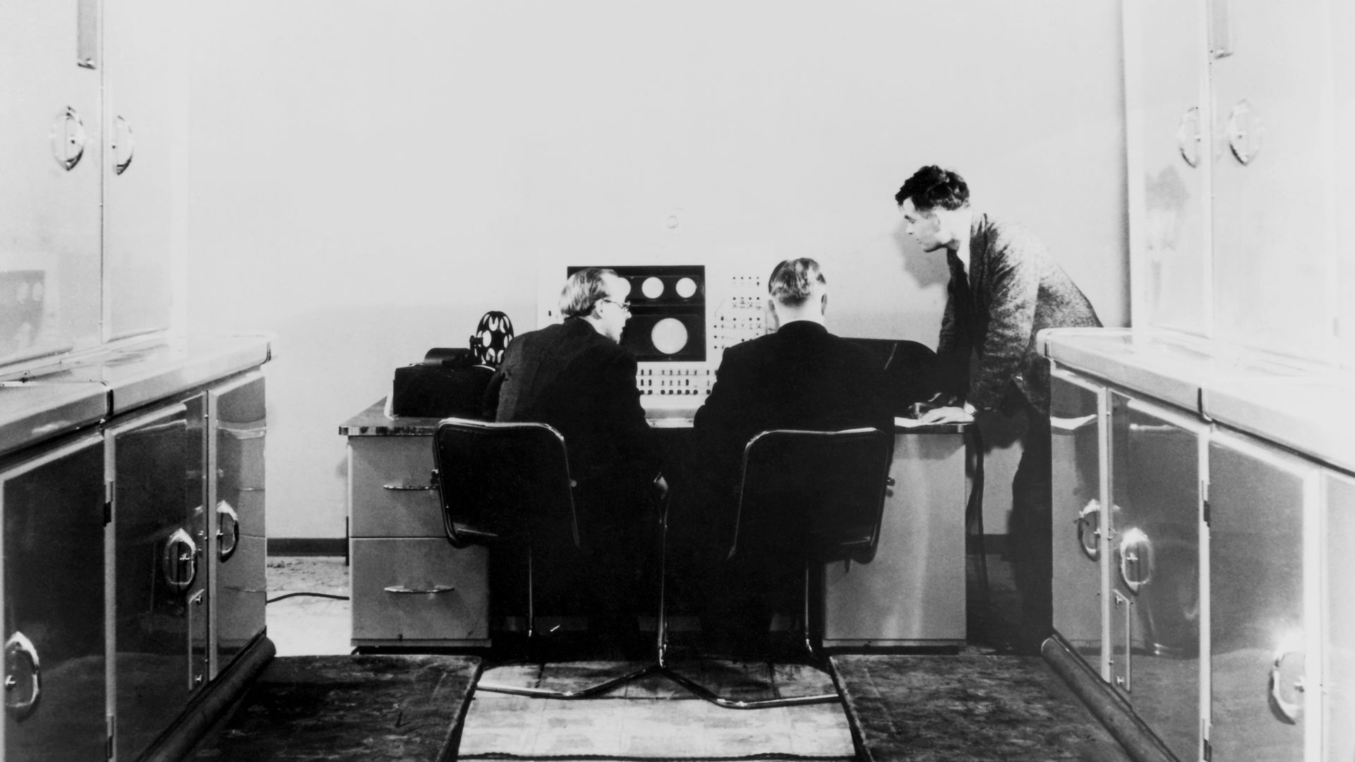 Alan Turing and colleagues working on the Ferranti Mark I Computer, 1951.