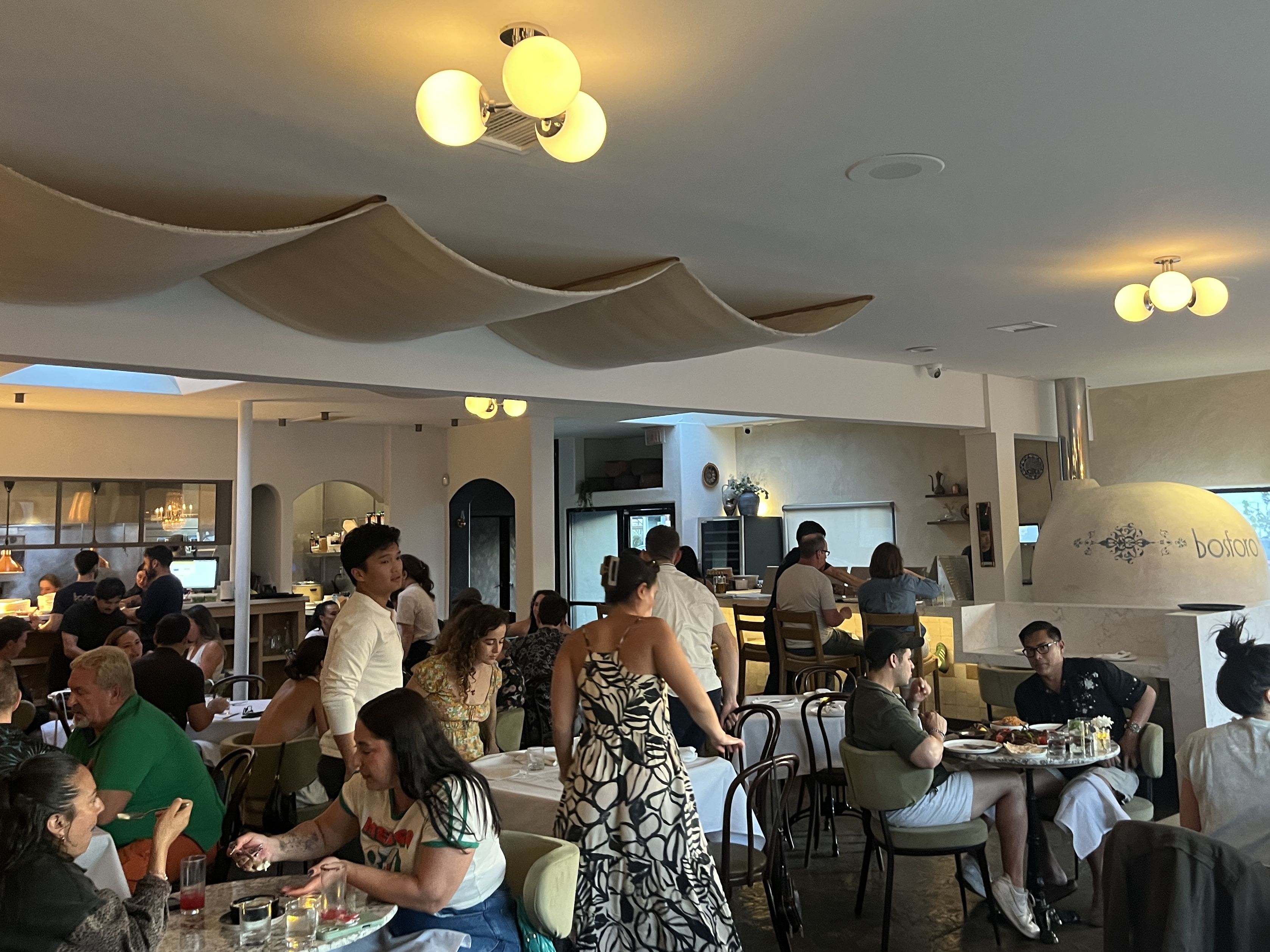 An open dining room at a restaurant filled with people. 