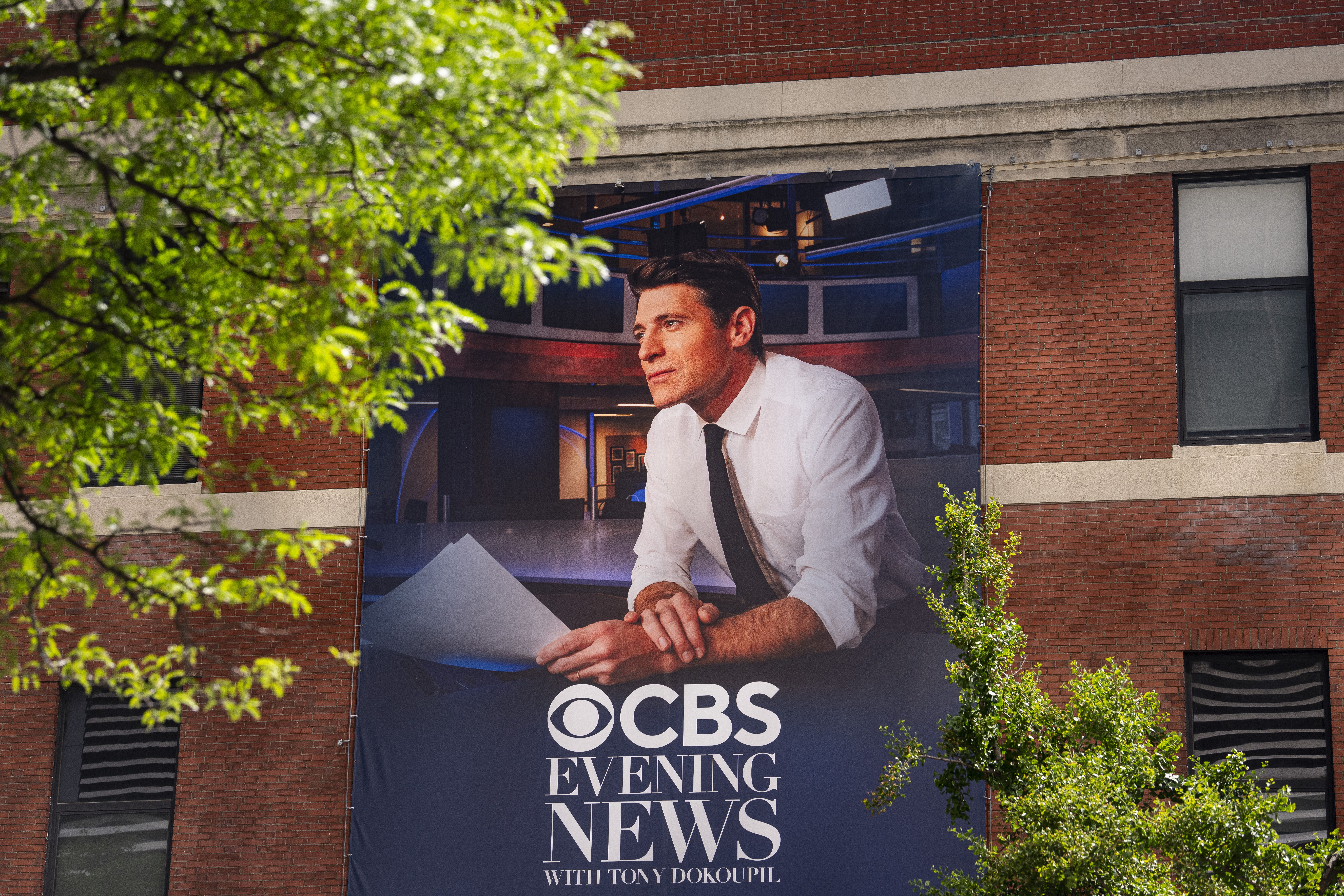 Tony Dokoupil, anchor of the "CBS Evening News," is emblazoned on a banner outside the CBS Broadcast Center in Manhattan. Photo: Al Drago/Getty Images