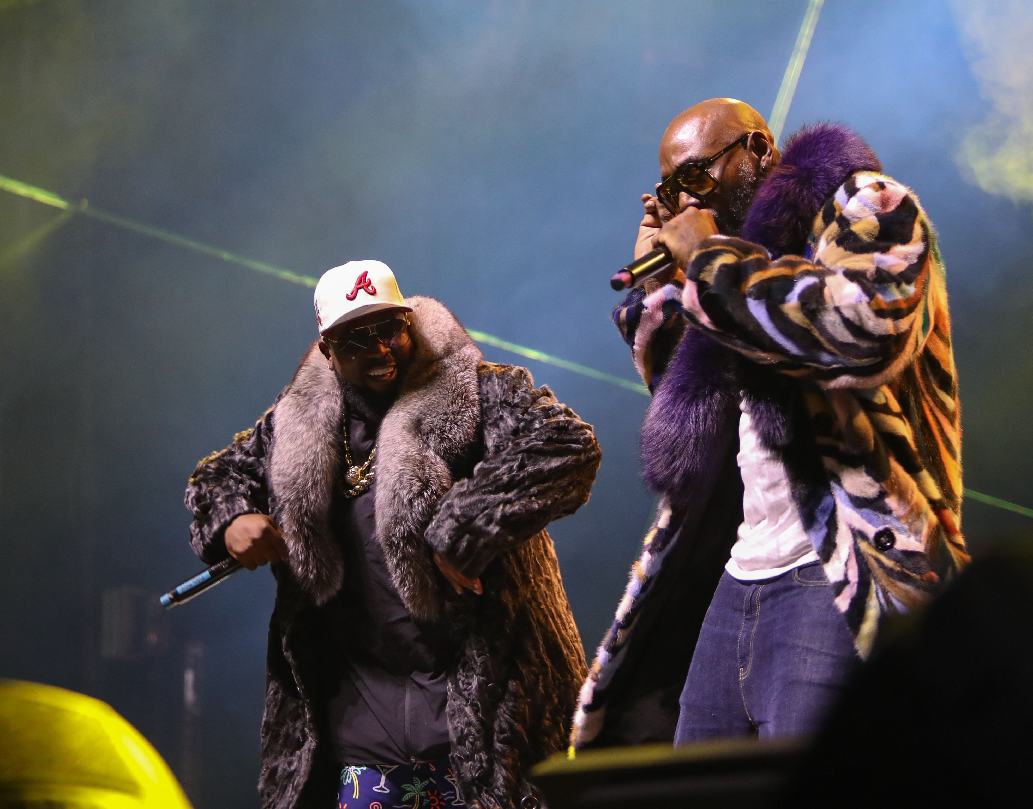 Photos shows Big Boi and Sleepy Brown performing on stage and wearing long coats during summer in New Orleans.