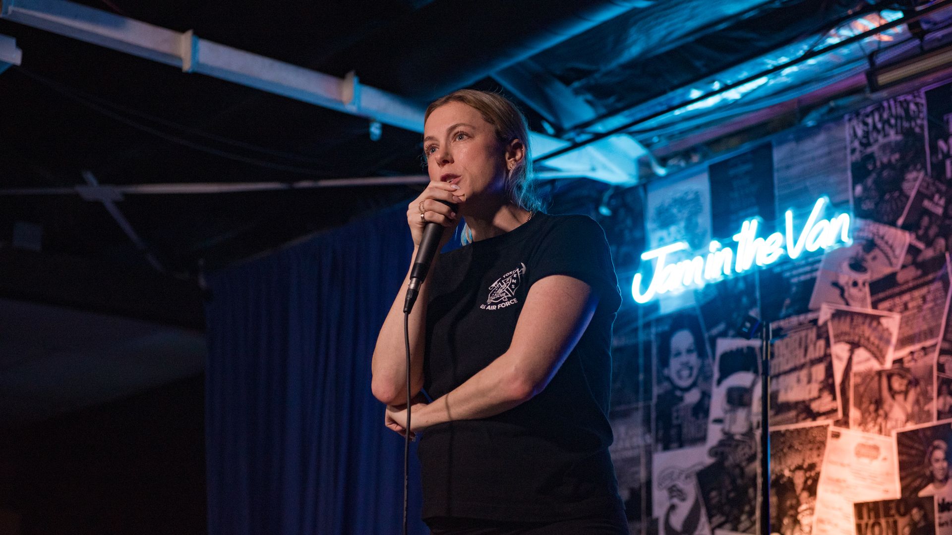 A woman standing with the microphone