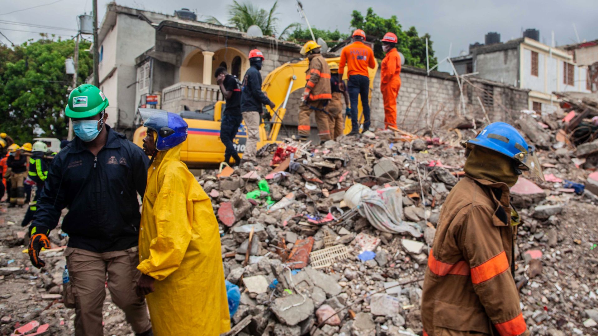 Firefighters remove debris in search of survivors after a 7.2-magnitude earthquake struck Haiti