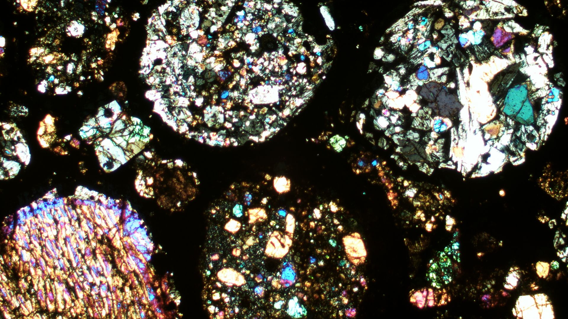 A thin section of primitive meteorite under a microscope. 