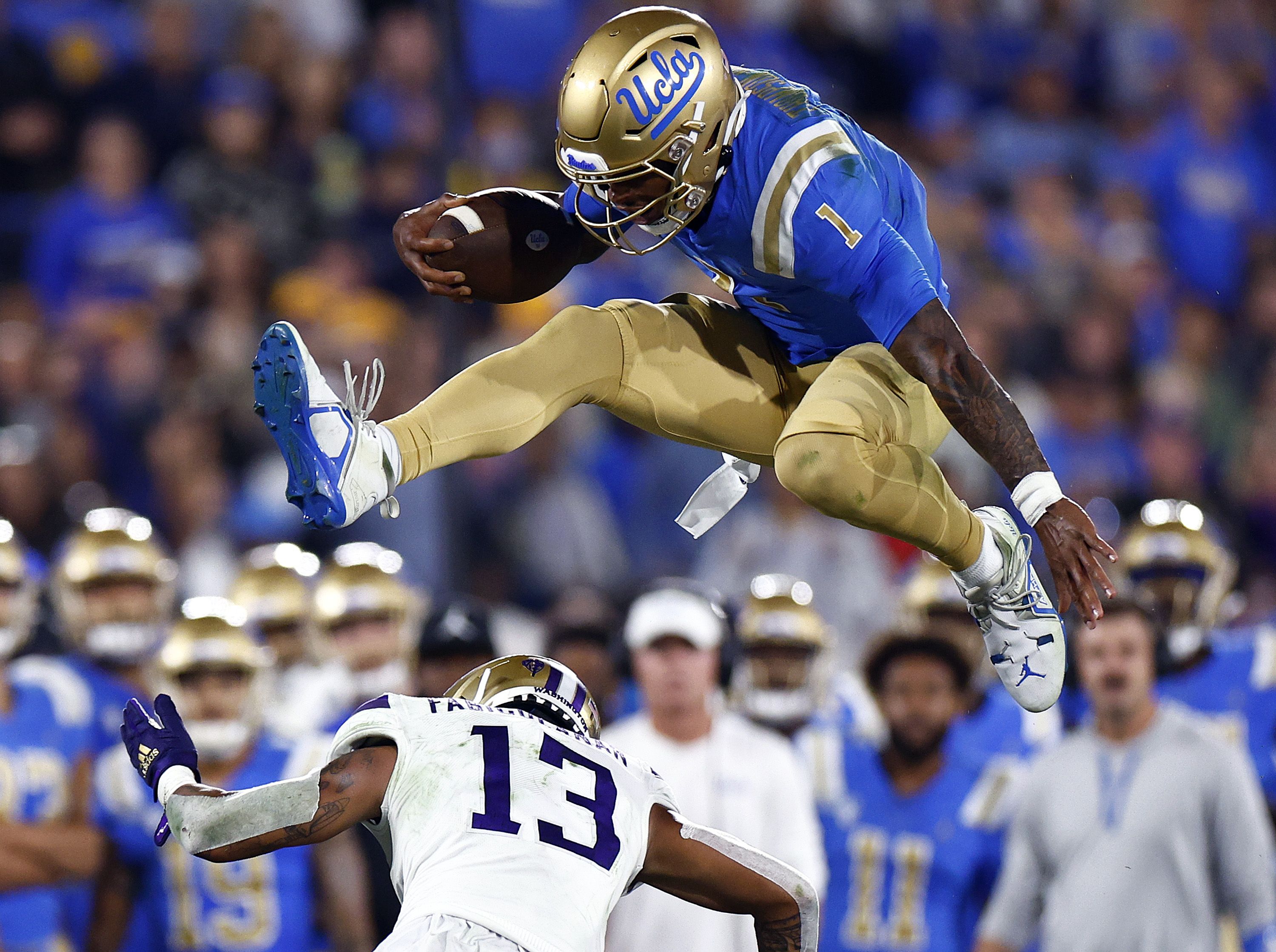 Dorian Thompson-Robinson hurdles a defender