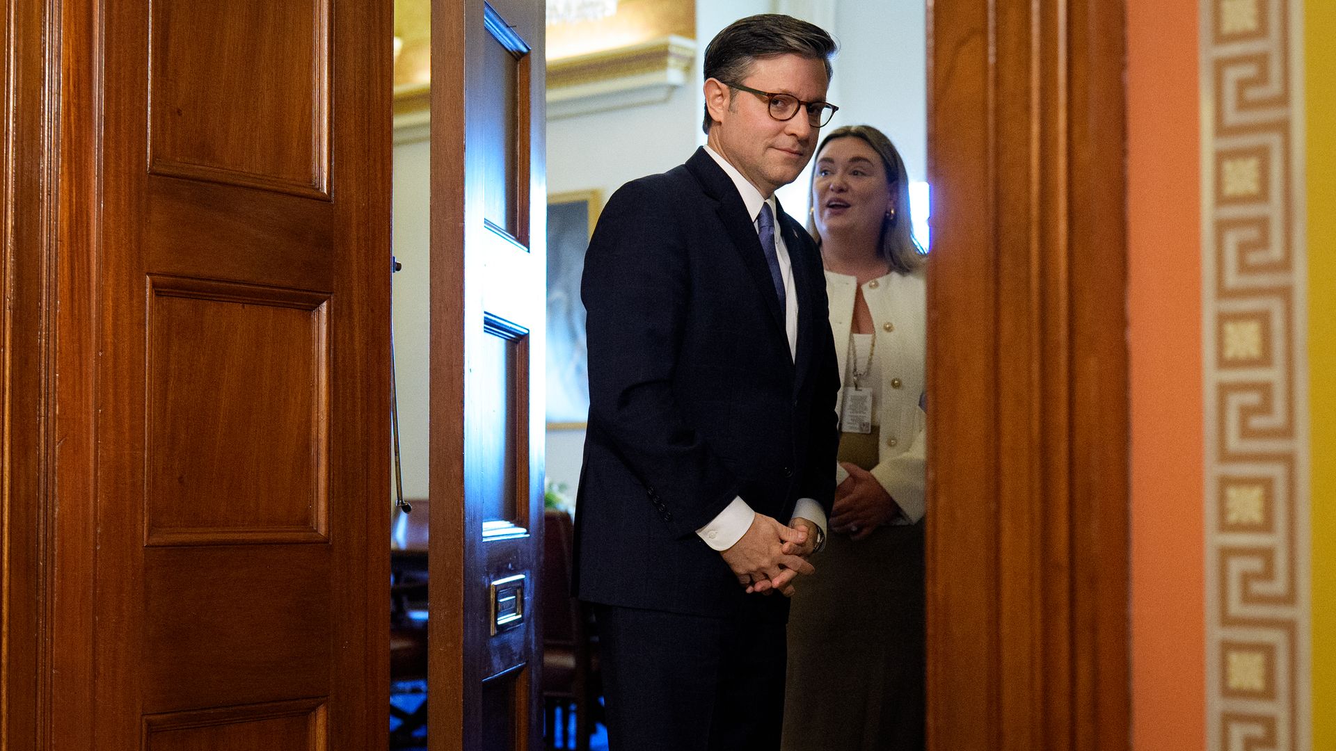 Speaker Mike Johnson waits in a doorway at the Capitol to greet His All Holiness Ecumenical Patriarch and Archbishop of Constantinople Bartholomew 