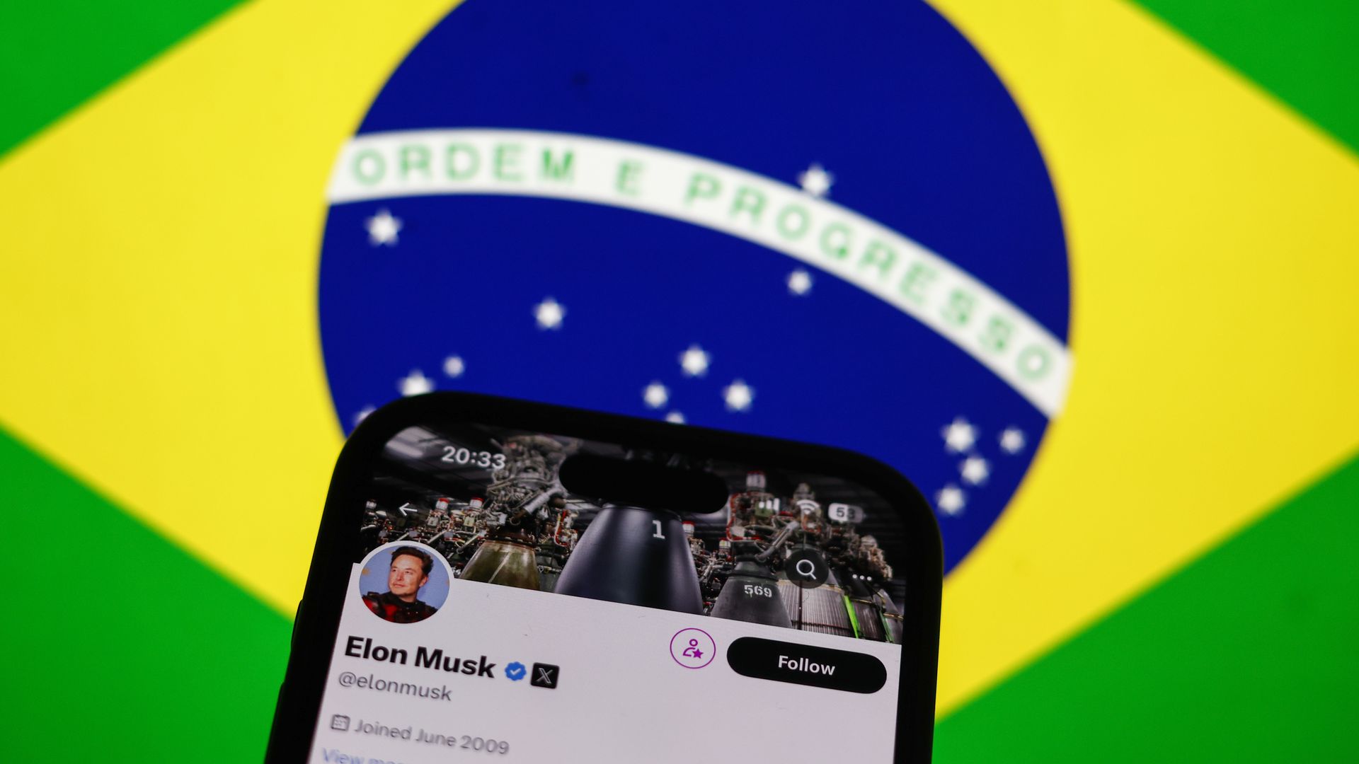 Brazilian flag displayed on a laptop screen and Elon Musk account on X displayed on a phone screen are seen in this illustration photo taken in Krakow, Poland on September 2, 2024. 