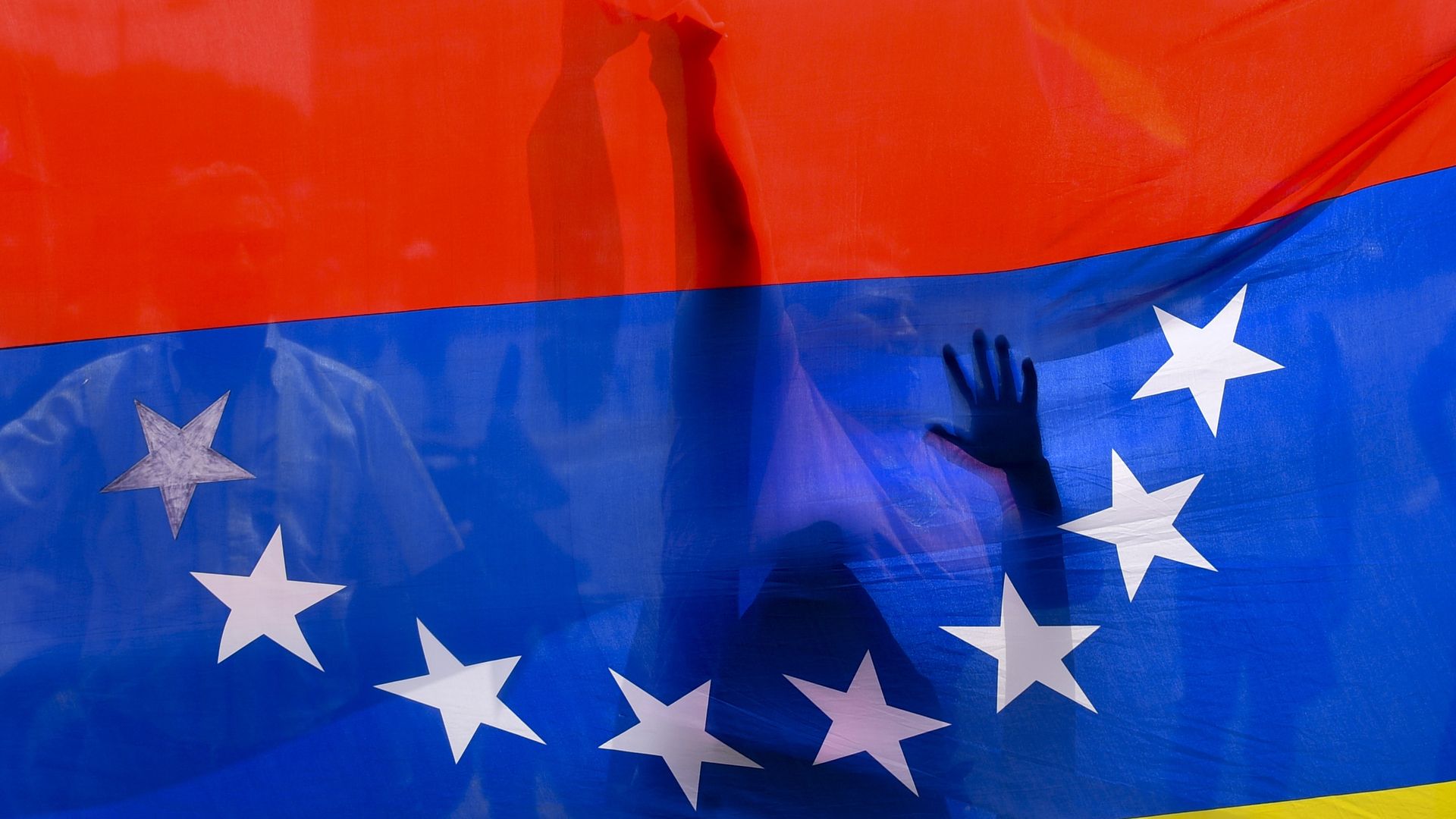 People behind Venezuela's flag.