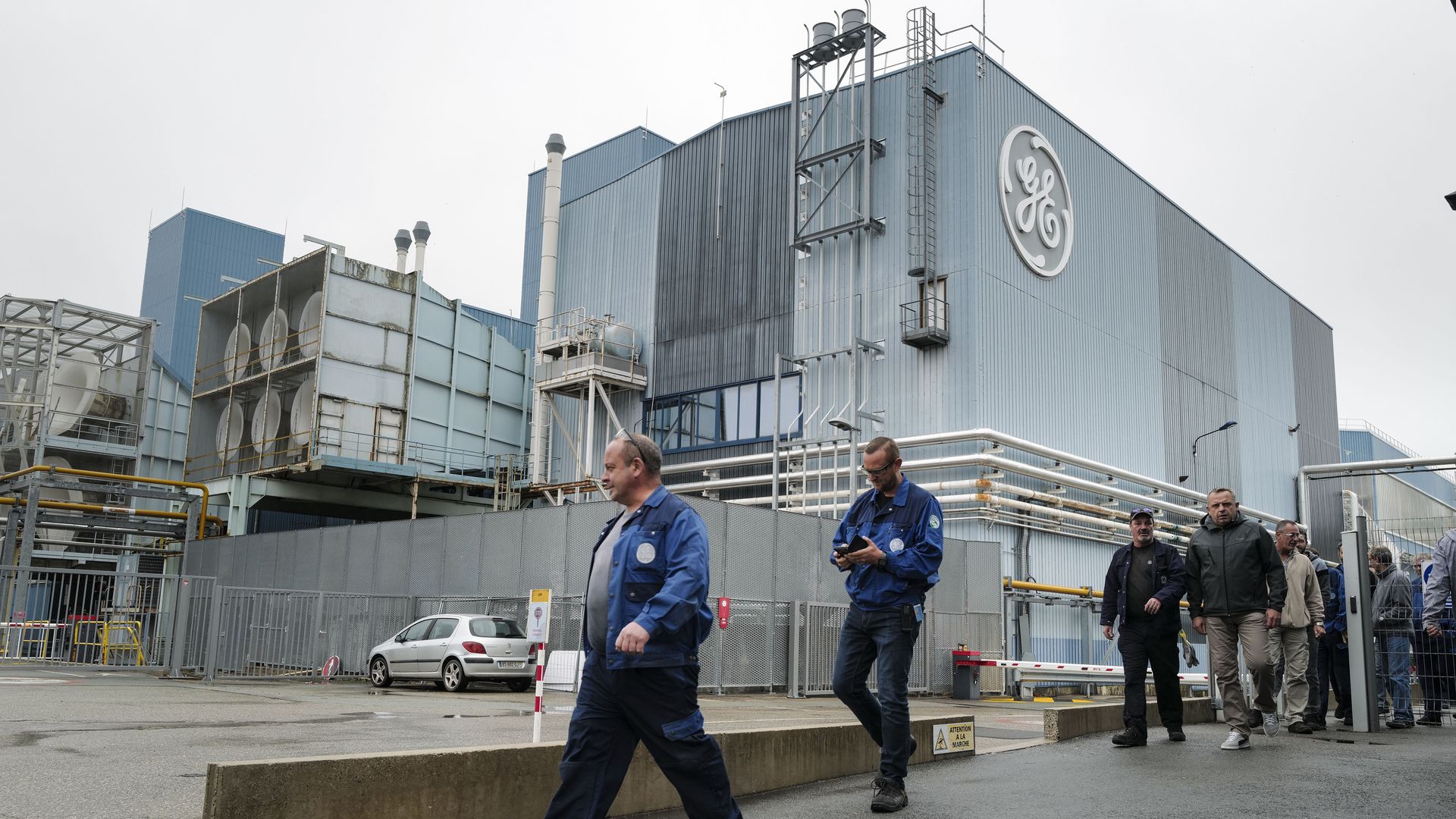 General Electric workers in front of a factory 