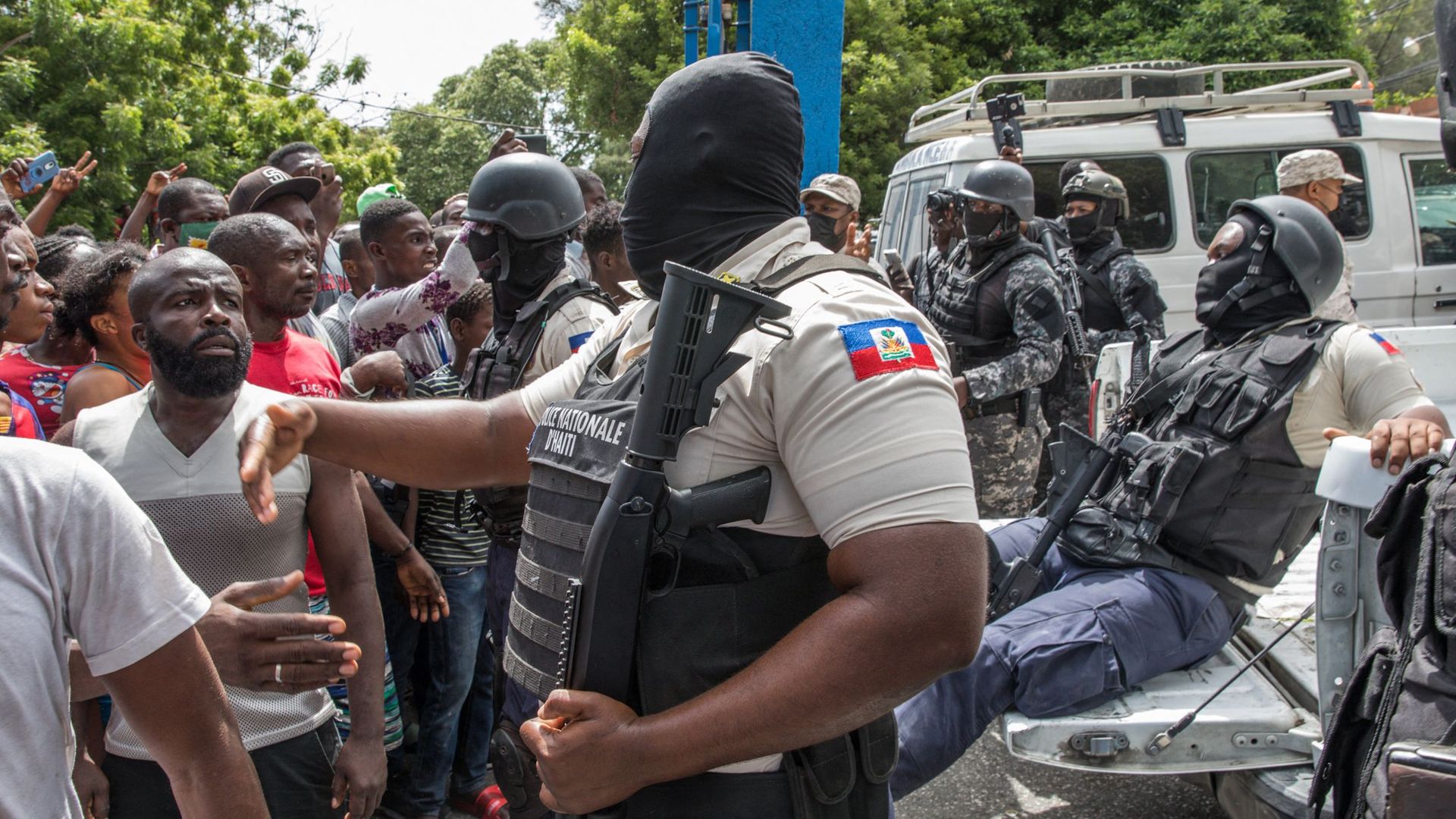 Police directing people outside of a police station in Port au Prince on July 8.
