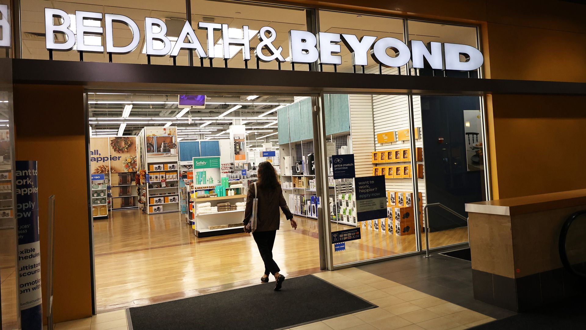 A customer walks into a Bed Bath & Beyond retail store