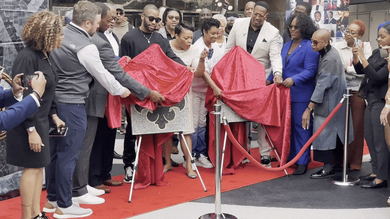 Image shows people unveiling the plaques.