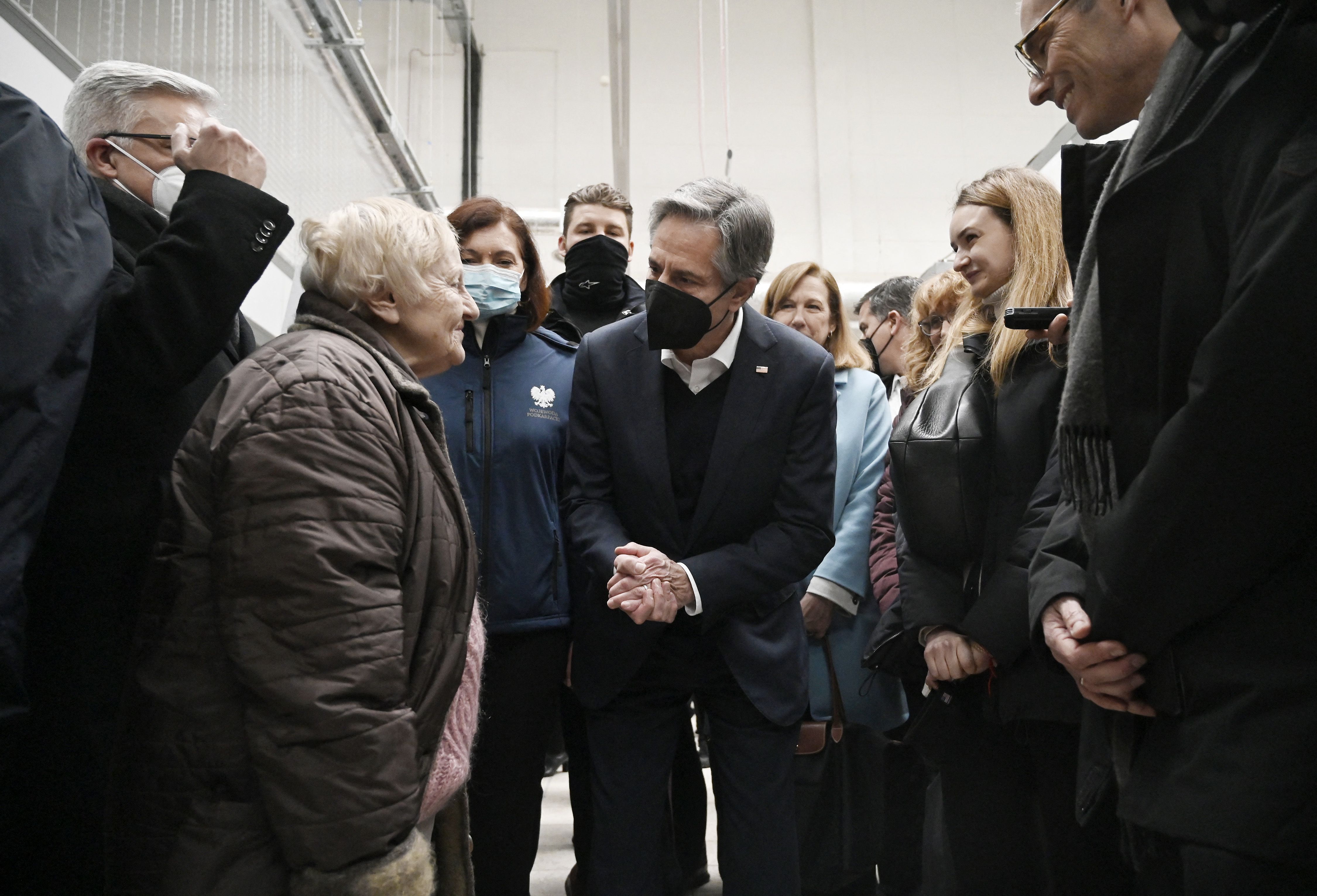 Secretary of State Antony Blinken (C) meets with refugees at a refugee reception center at the Ukrainian-Polish border crossing in Korczowa on March 5, 2022 
