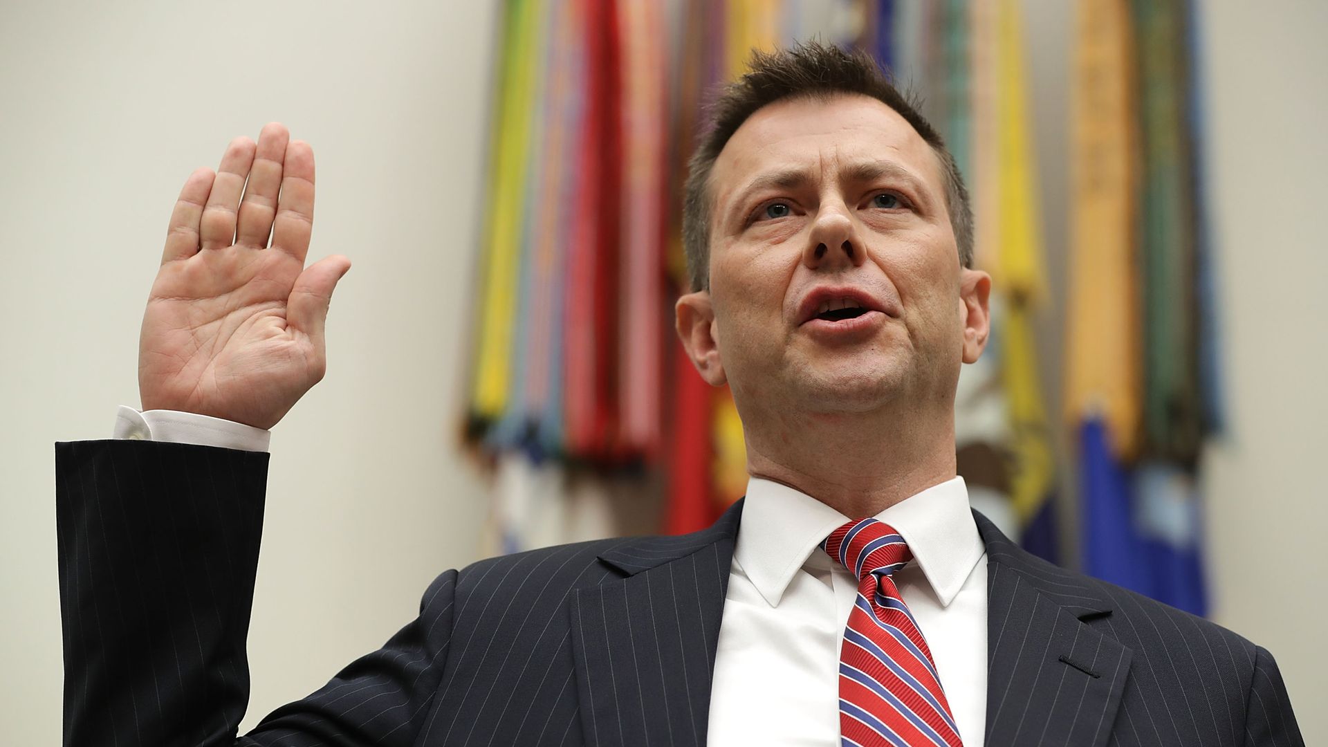 Strzok raises his hand to take an oath