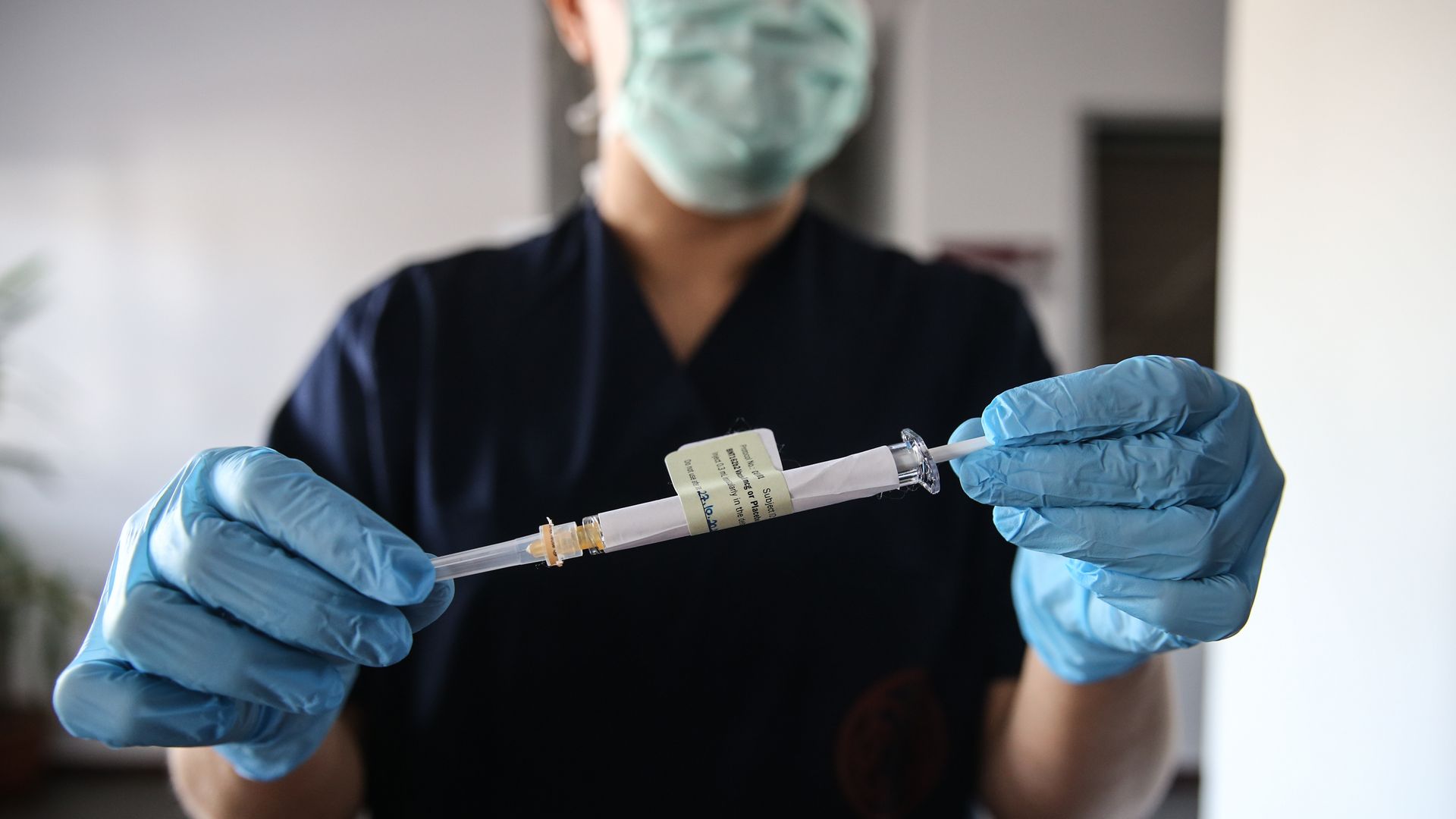 A health care worker holds an injection syringe of the phase 3 vaccine trial, developed against COVID-19 by the U.S. Pfizer and German BioNTech  in Ankara, Turkey on October 27