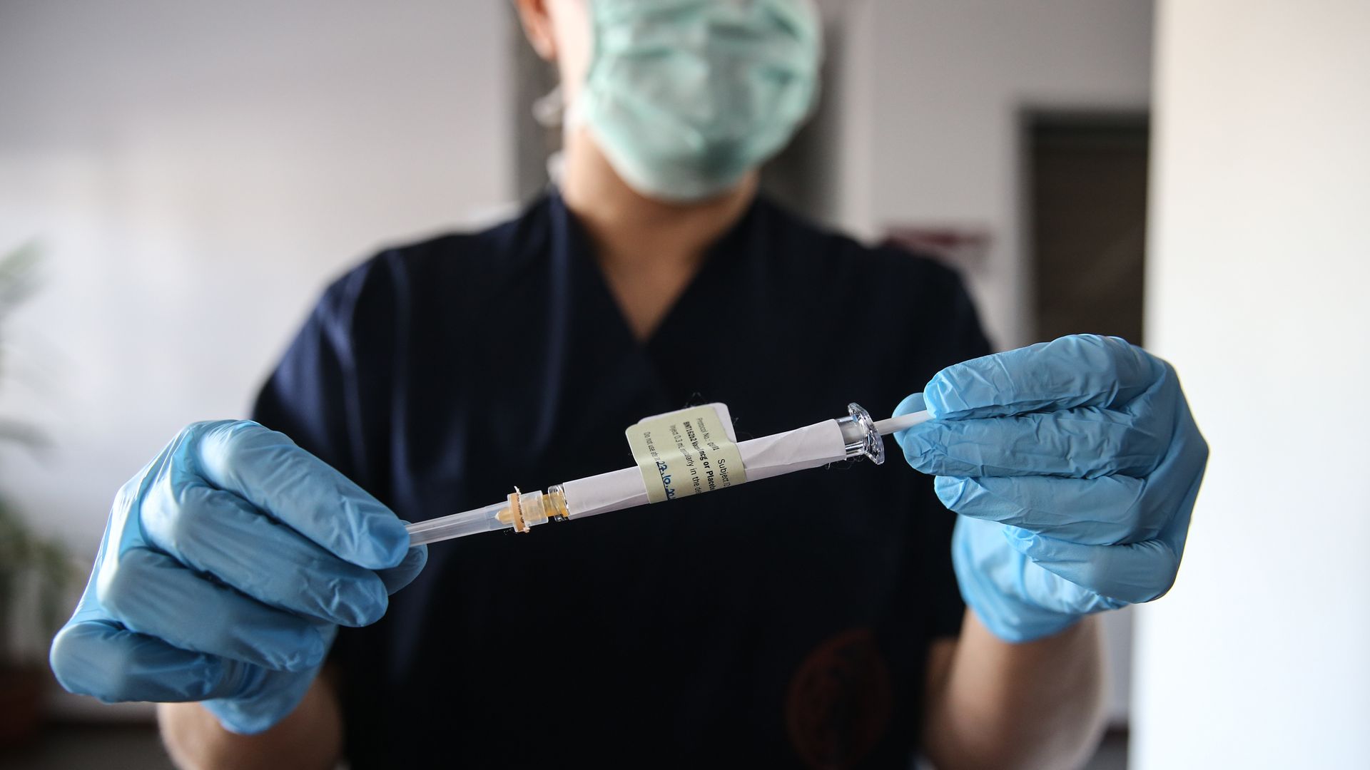A health care worker holds an injection syringe of the phase 3 vaccine trial, developed against COVID-19 by the U.S. Pfizer and German BioNTech in Ankara, Turkey on October 27