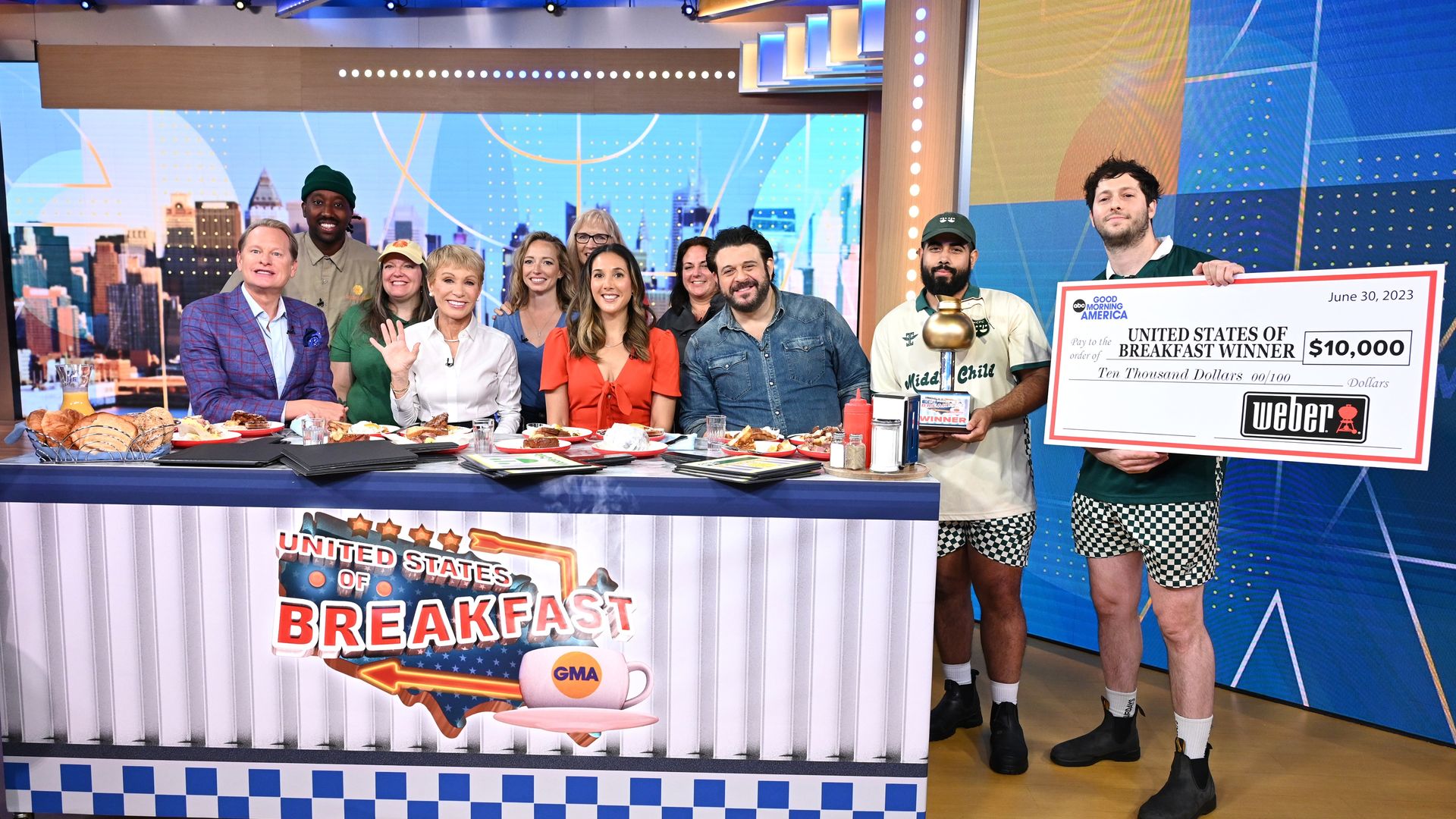 "Good Morning America" hosts and judges present a check for $10,000 to the owner of Middle Child restaurant, Matthew Cahn, and executive chef Edwin De La Rosa.