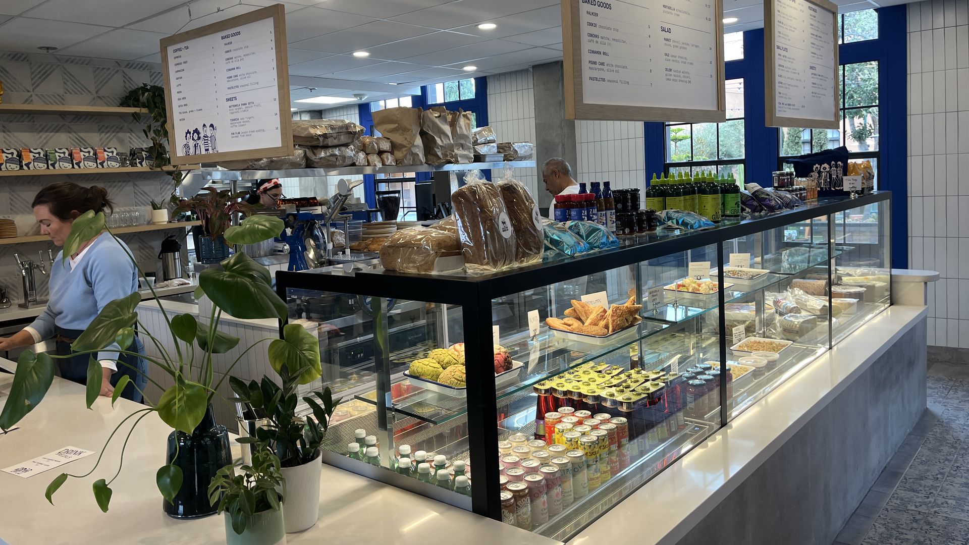 Wildflour's deli counter filled with bread, sauces, drinks, pastries and other food items.