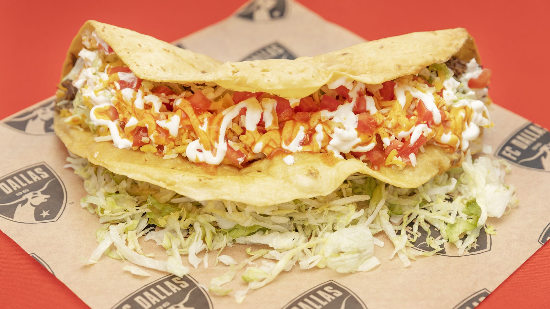 A giant taco filled with meat, cheese, lettuce