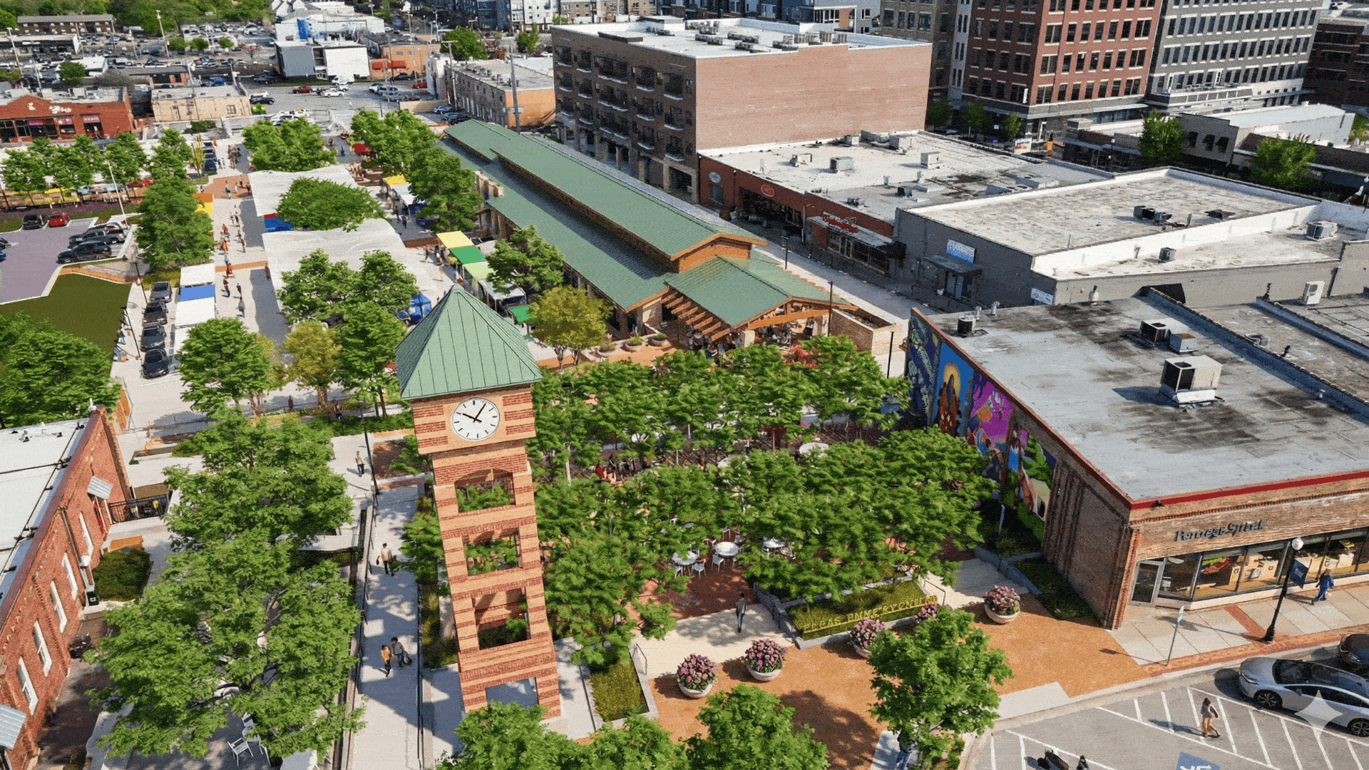 Aerial view of a lively downtown square with a tall brick clock tower in the foreground, green-roofed market buildings, trees, outdoor seating, and surrounding brick streets filled with people.