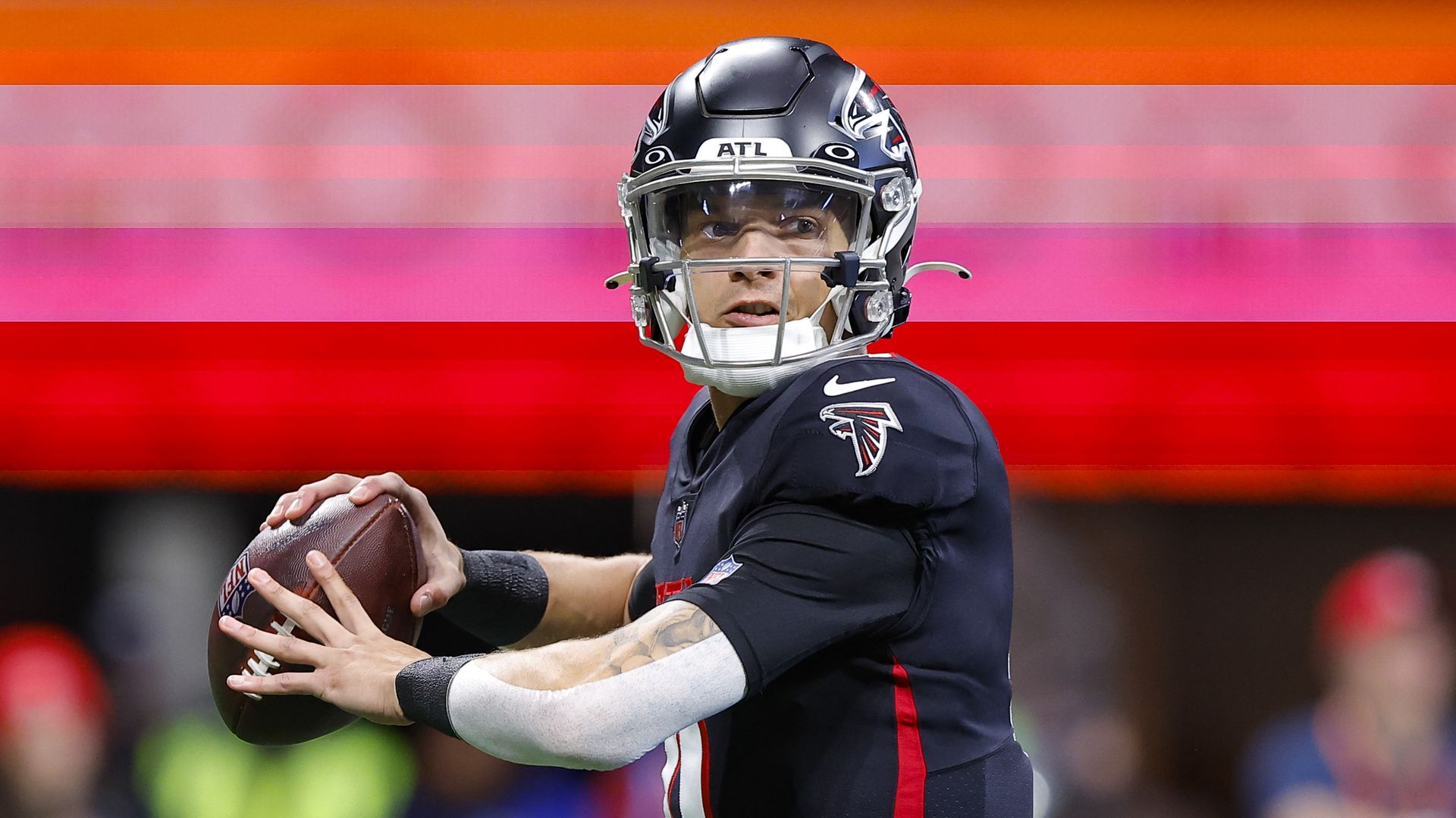 Atlanta Falcons Desmond Ridder, wearing a black uniform, prepares to throw the football 