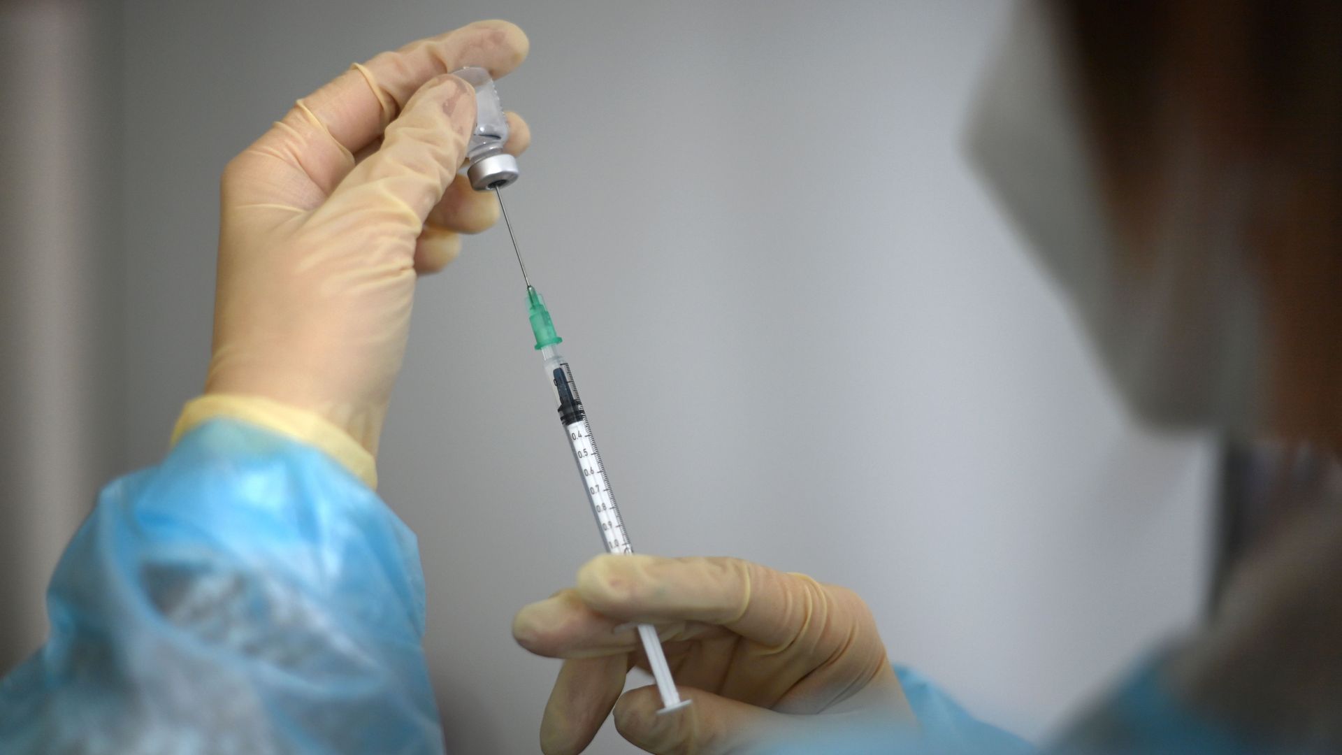 Photo of a health care worker preparing a vaccine injection