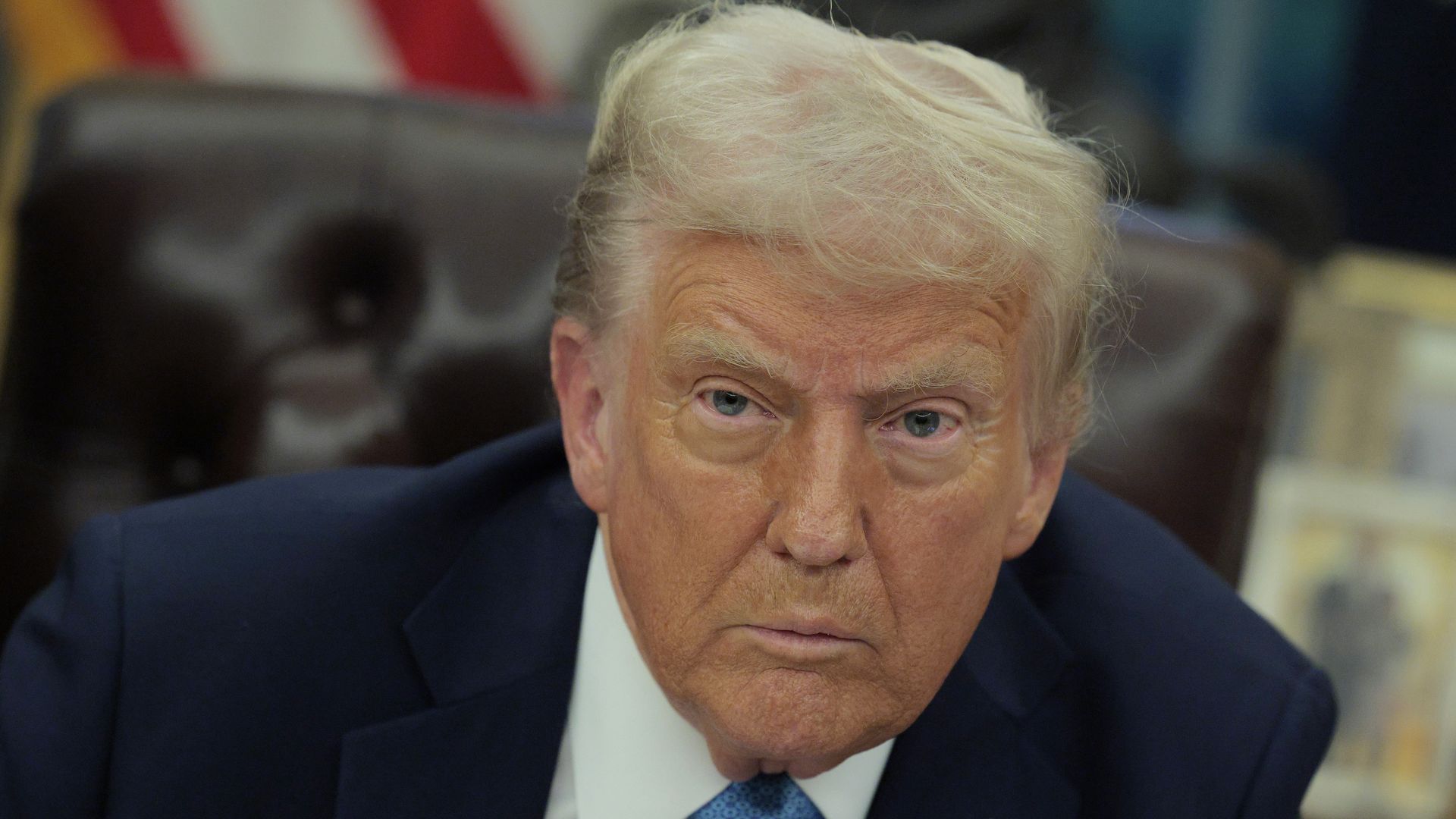 Headshot of white man with blonde hair in navy suit