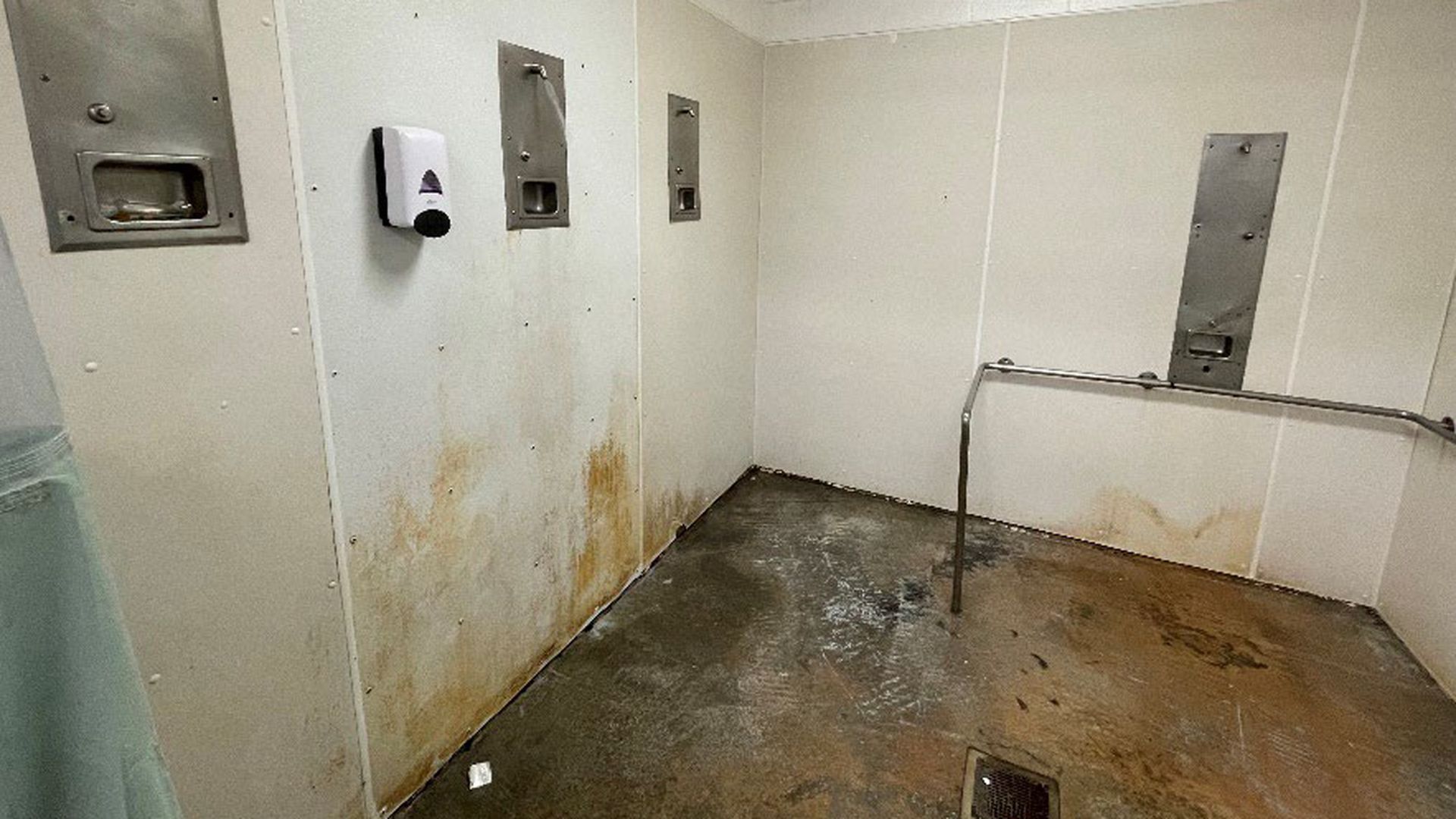 A photograph of a moldy shower area.